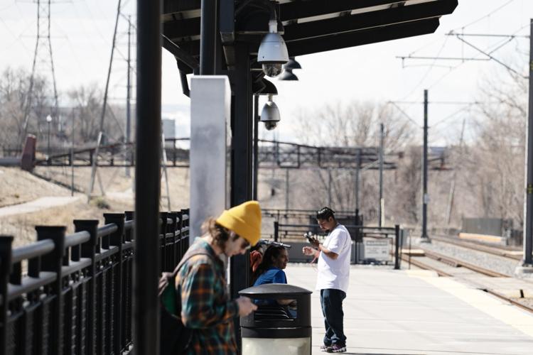 Passengers wait for arriving RTD trains
