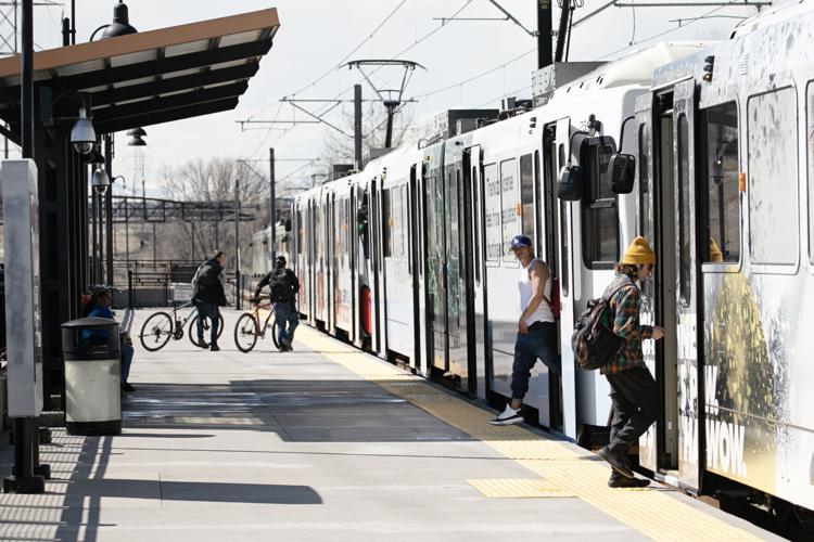 Passengers board and step off an RTD train