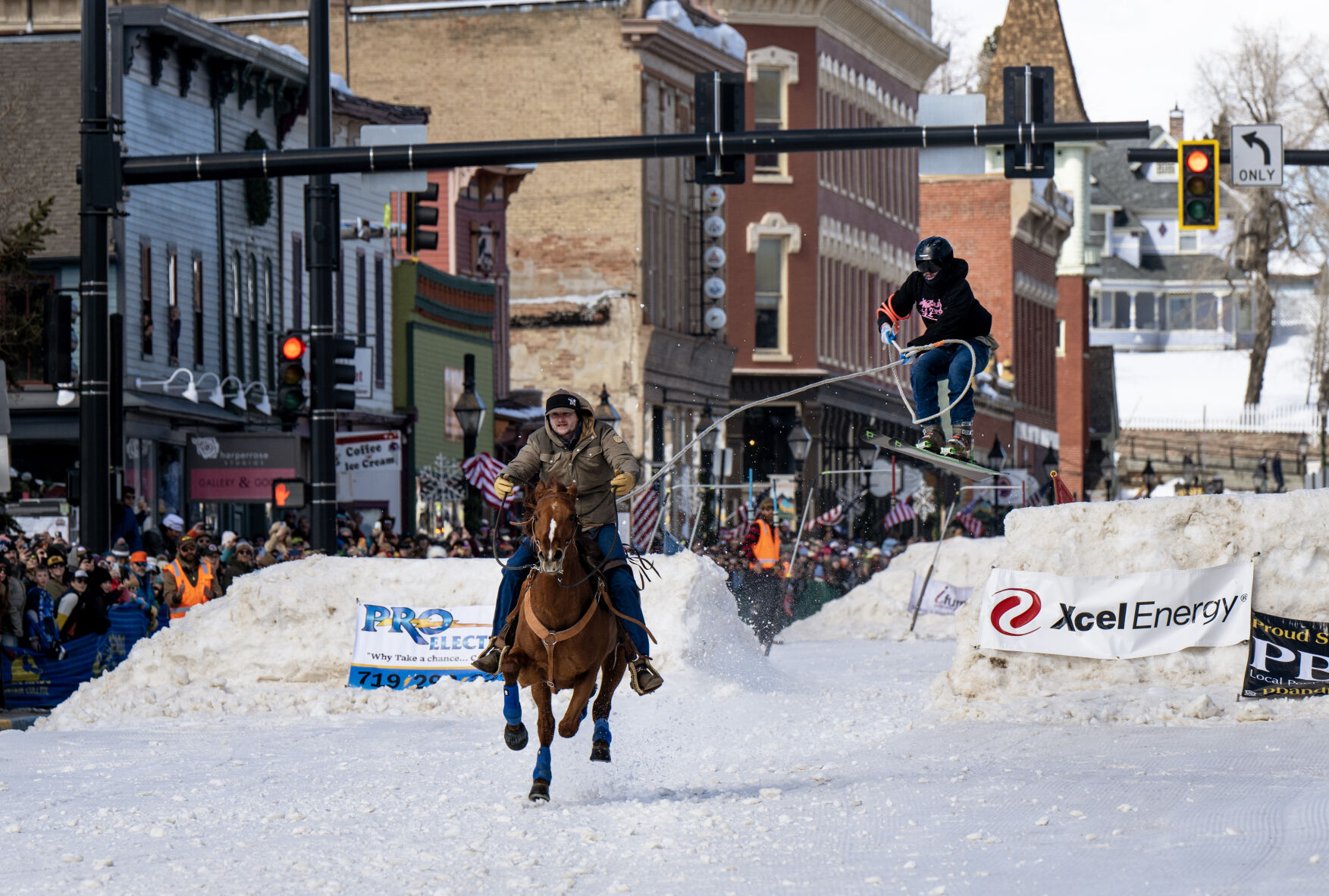 A horse and rider pull a skier over a jump at the 76th Annual Leadville Ski Joring on Saturday, March 2, 2024, in Leadville, Colo. (Parker Seibold, The Gazette) (Parker Seibold)