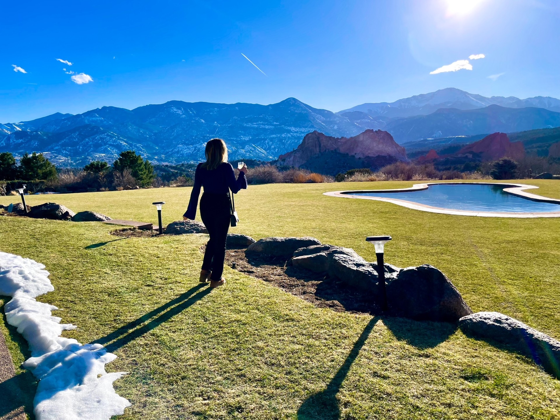 Chandler Boyd enjoys the scene that fills the backdrop of the Grand View restaurant at Garden of the Gods Resort, complete with Pikes Peak, the Garden of the Gods, and a reflection pool. Photo Credit: Spencer McKee.