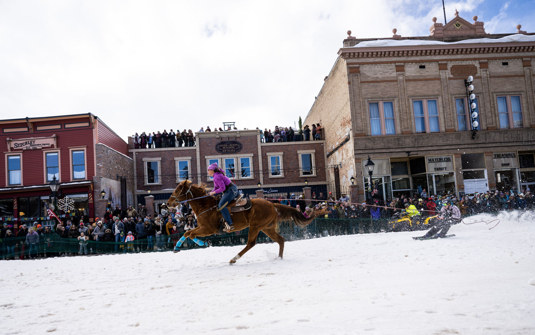 A rider and her horse pull a skier past hundreds of spectators as they compete at the 76th Annual Leadville Ski Joring on Saturday, March 2, 2024, in Leadville, Colo. (Parker Seibold, The Gazette) (Parker Seibold)