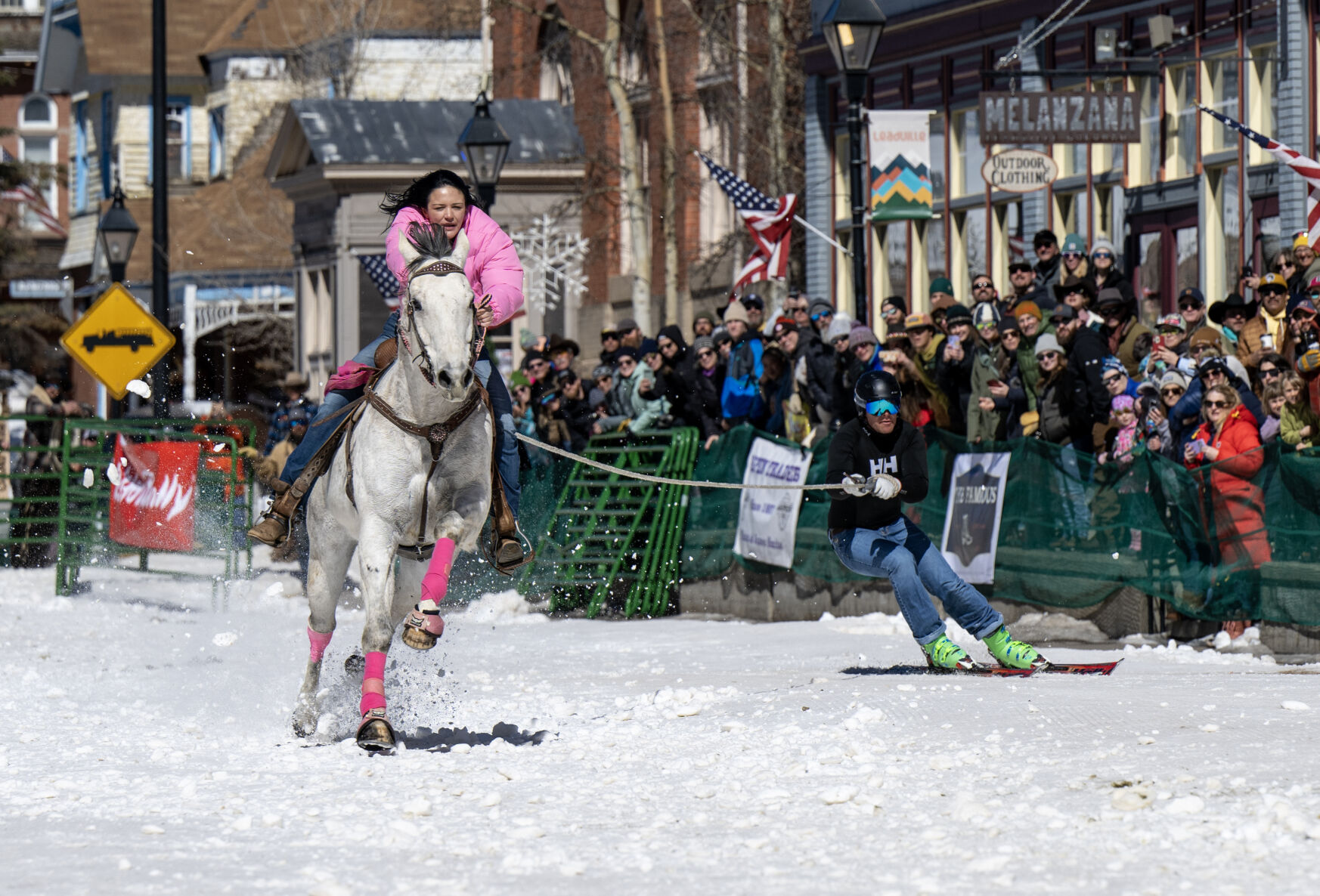 Savannah McCarthy pulls Greg Dahl in the open division of the 76th Annual Leadville Ski Joring on Saturday, March 2, 2024, in Leadville, Colo. Thousands of people lined Leadville’s historic Harrison Avenue for the event, which continues at noon on Sunday. (Parker Seibold, The Gazette) (Parker Seibold)