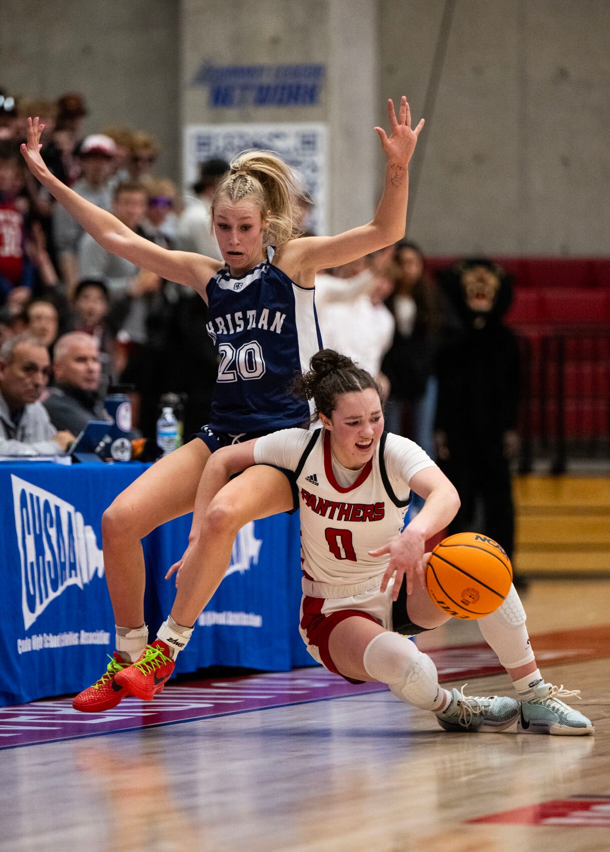Peyton’s AJ Mannering falls into Colorado Springs Christian School’s Kinley Asp (20) in the second half of the 3A girls basketball state championships on Saturday, March 9, 2024, at the University of Denver’s Hamilton Gym in Denver. (Parker Seibold, The Gazette) (Parker Seibold)