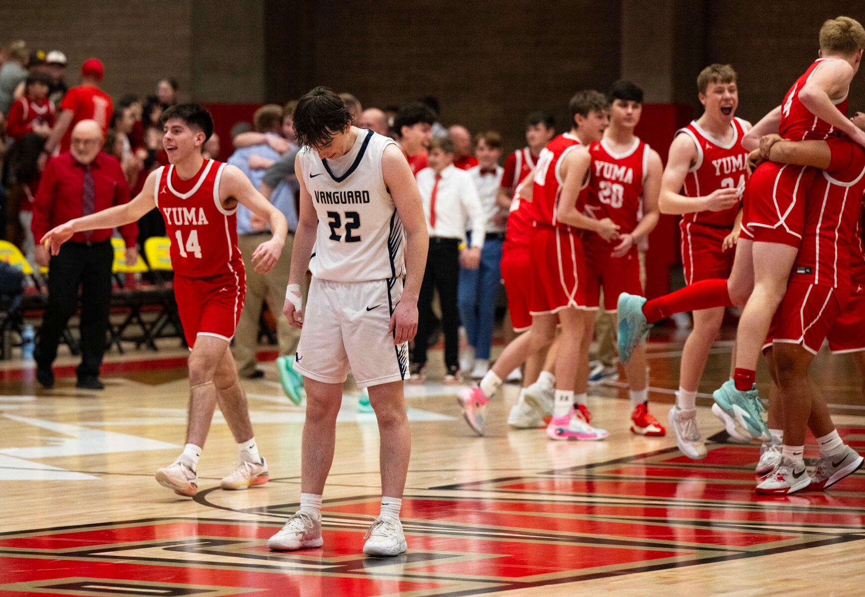 Vanguard’s Nathan Morris (22) freezes in the center of the court as the Yuma basketball team celebrates their win at the last buzzer of the 3A boys basketball state championships on Saturday, March 9, 2024, at the University of Denver’s Hamilton Gym in Denver. (Parker Seibold, The Gazette) (Parker Seibold)