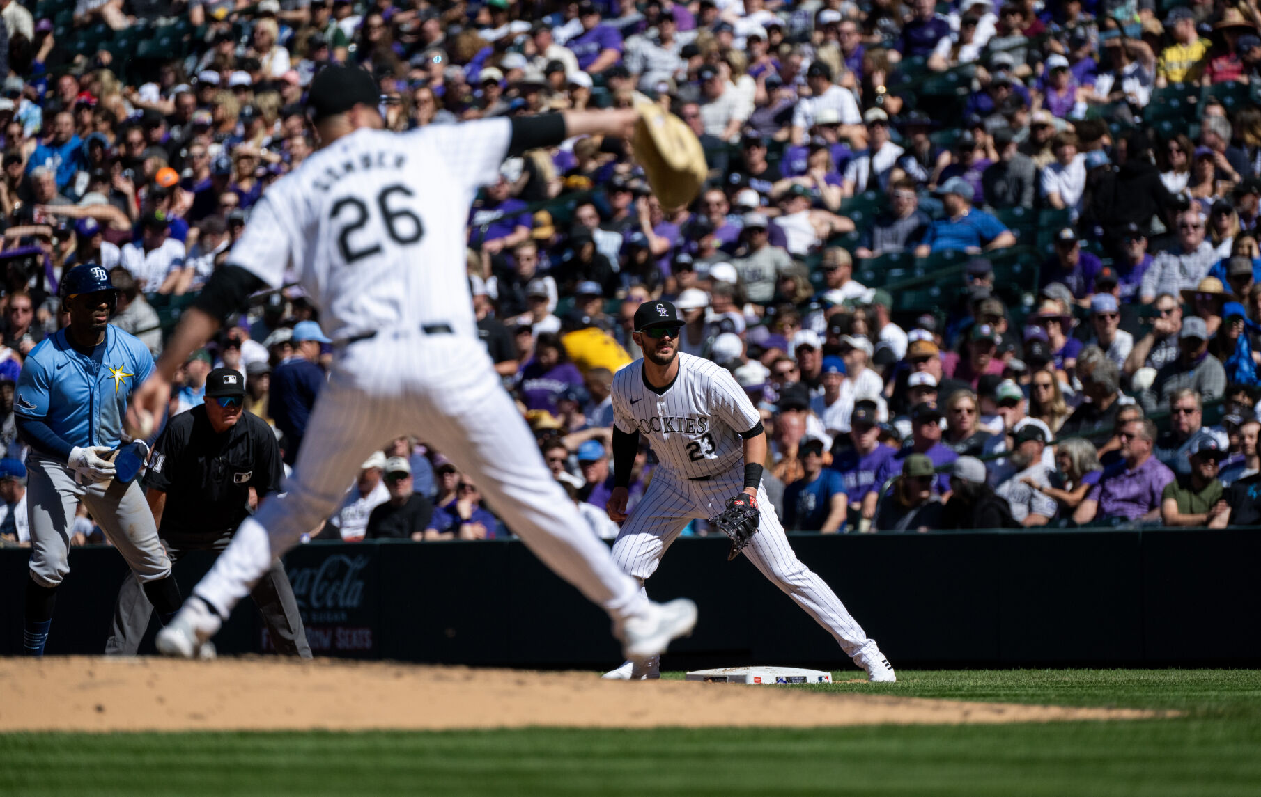 Colorado Rockies infielder Kris Bryant (23) watches from first base as pitcher Austin Gomber (26) throws a pitch during a game against the Tampa Bay Rays at Coors Field, Friday, April 5, 2024, in Denver, Colo. (Parker Seibold, The Gazette) (Parker Seibold)