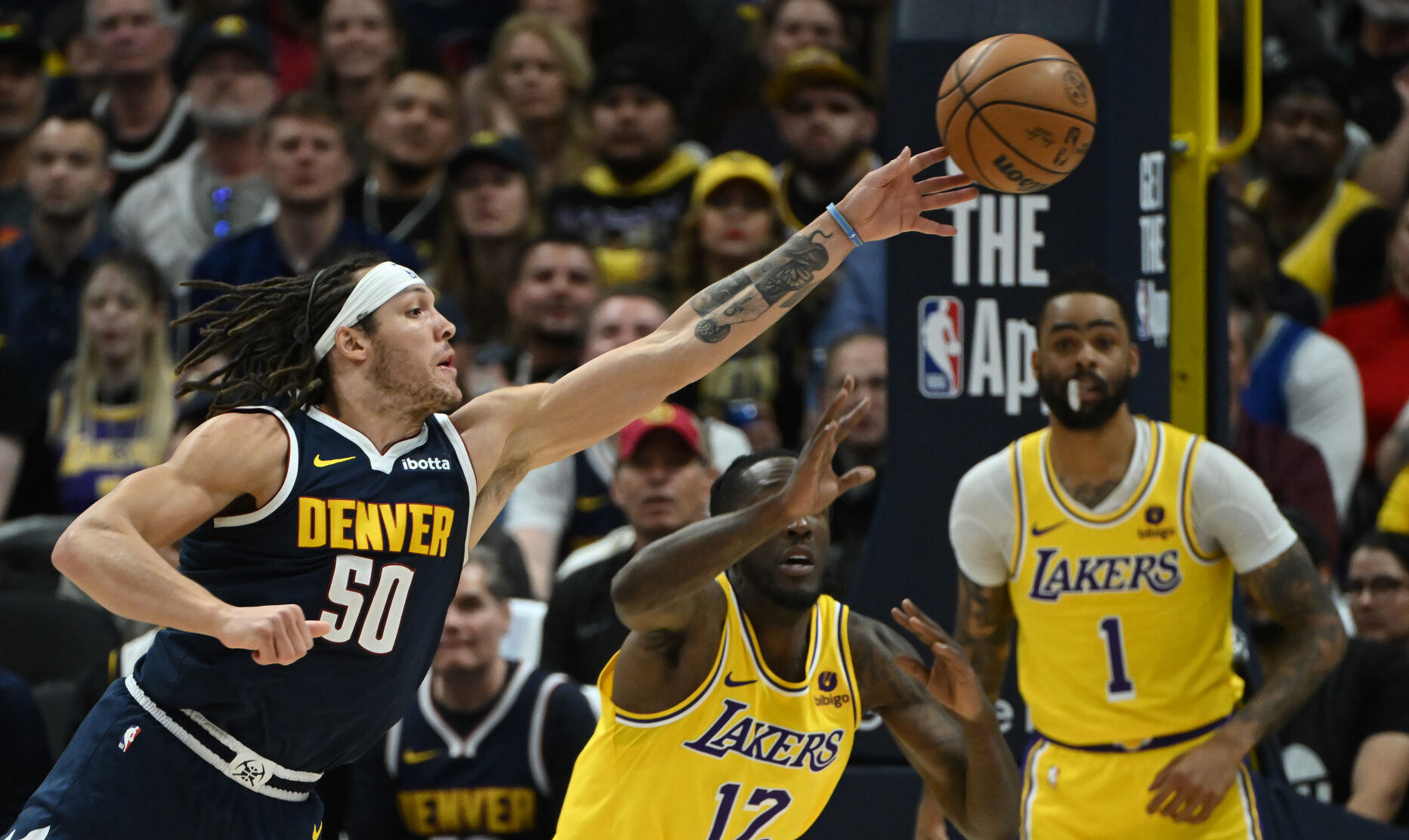 Aaron Gordon tips the ball to Michael Porter, Jr. who shoots a three pointer during the second quarter of game 5 of the first round of the Western Conference championships on Monday, April 29, 2024. (Photo by Jerilee Bennett, The Gazette)