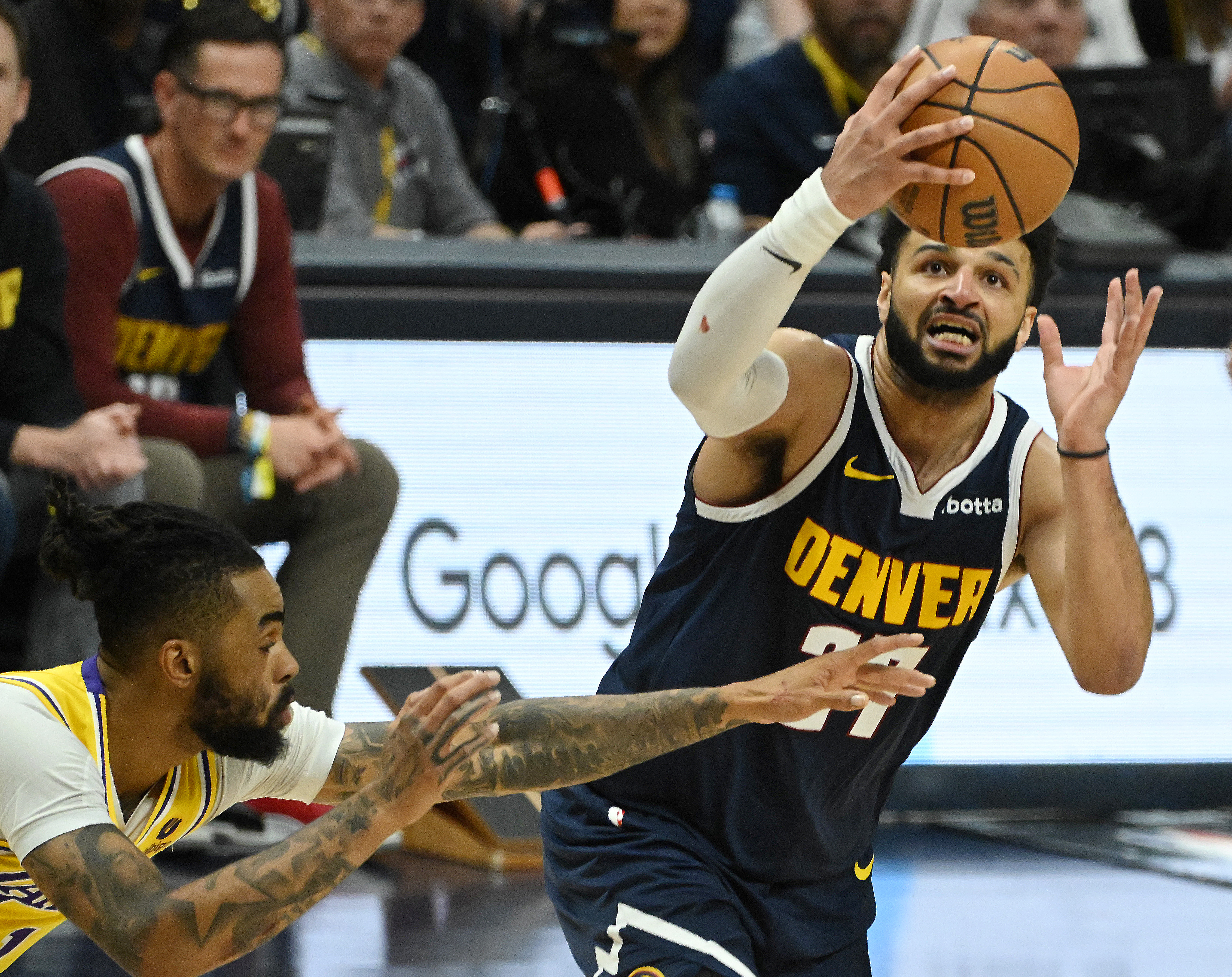 Jamal Murray takes a shot past Lakers’ D’Angelo Russell during game 5 of the first round of the Western Conference championships at Ball Arena on Monday, April 24, 2024. The Nuggets won the game 108-106. (Photo by Jerilee Bennett, The Gazette)