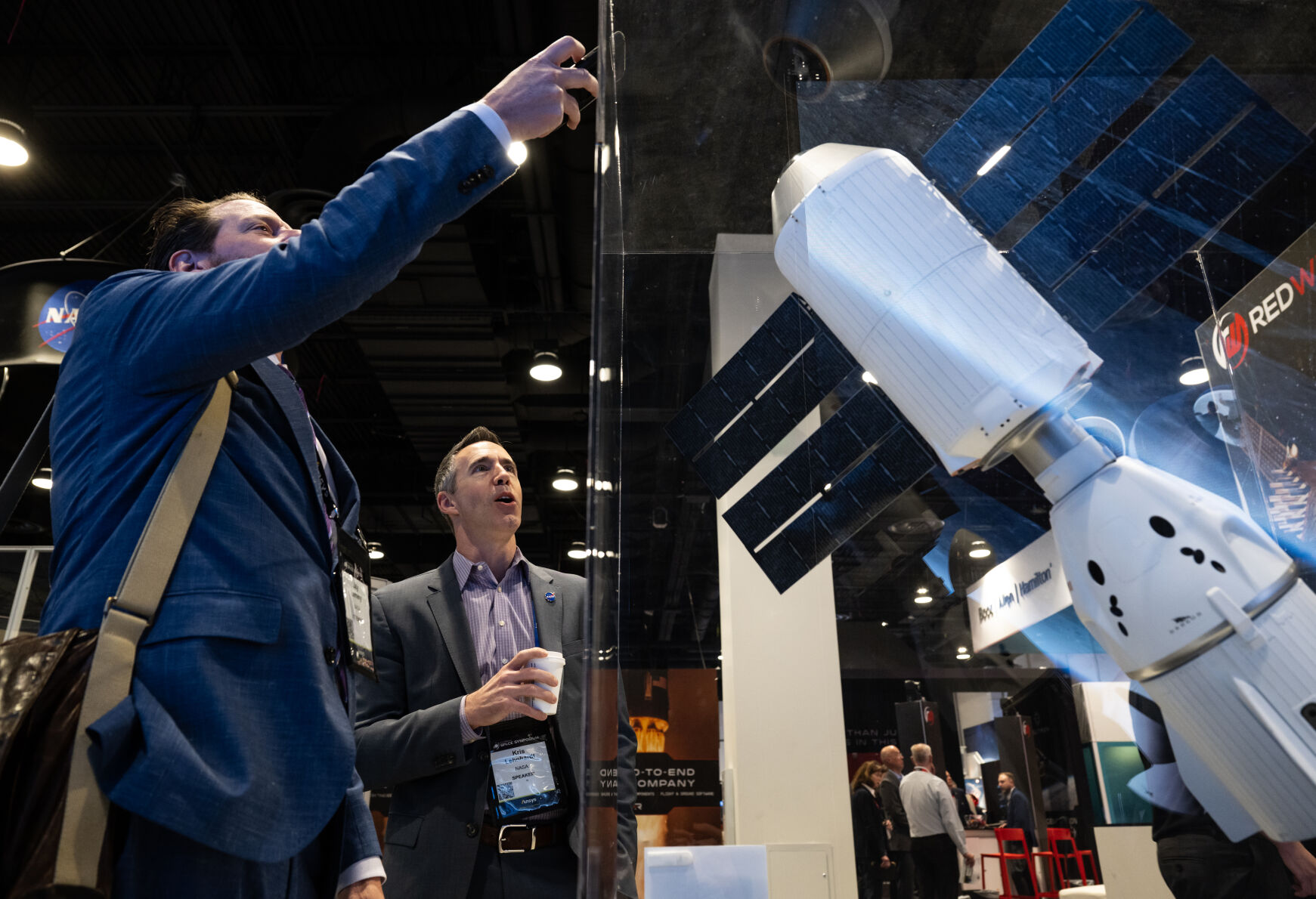 At the 39th Space Foundation Space Symposium NASA scientists Jay Lemery, left, and Kris Lehnhardt observe and photograph a model of Vast’s Haven-1, which the company hopes to launch as the world’s first commercial space station, at The Broadmoor Hotel, Tuesday, April 9, 2024, in Colorado Springs, Colo. (Parker Seibold, The Gazette) (Parker Seibold)