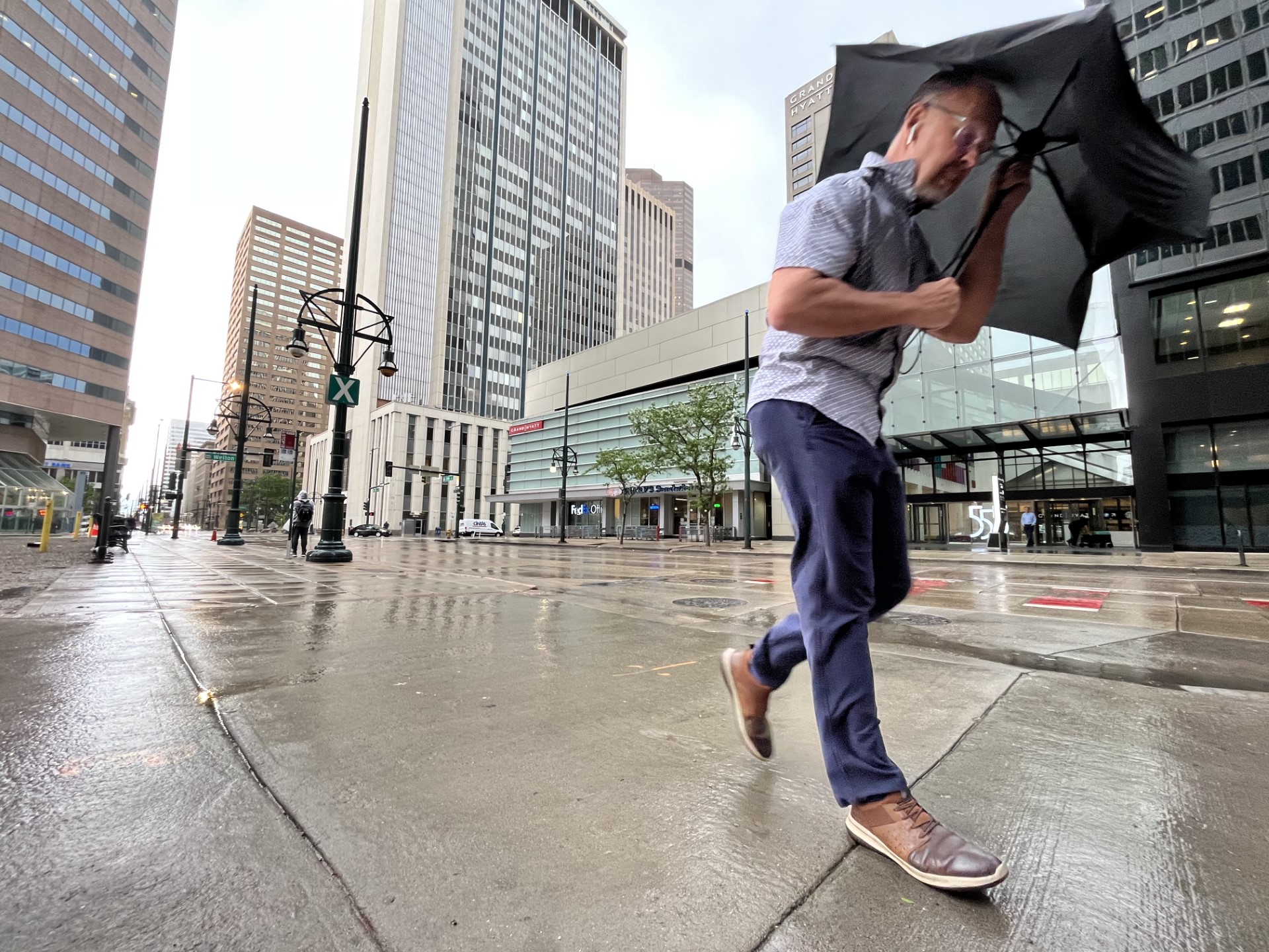 A pedestrian clutches an umbrella and leans into the wind and rain along 17th Street in downtown Denver. (JoeMahoneyDigital Producerjoe.mahoney@denvergazette.comhttps://secure.gravatar.com/avatar/ba16bfcfe6d41284ea08ff57c6ed80e9?d=mm&r=g)