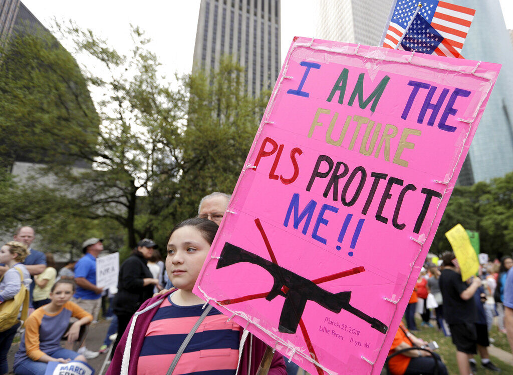 FILE PHOTO: Lillie Perez, 11, holds a sign during a