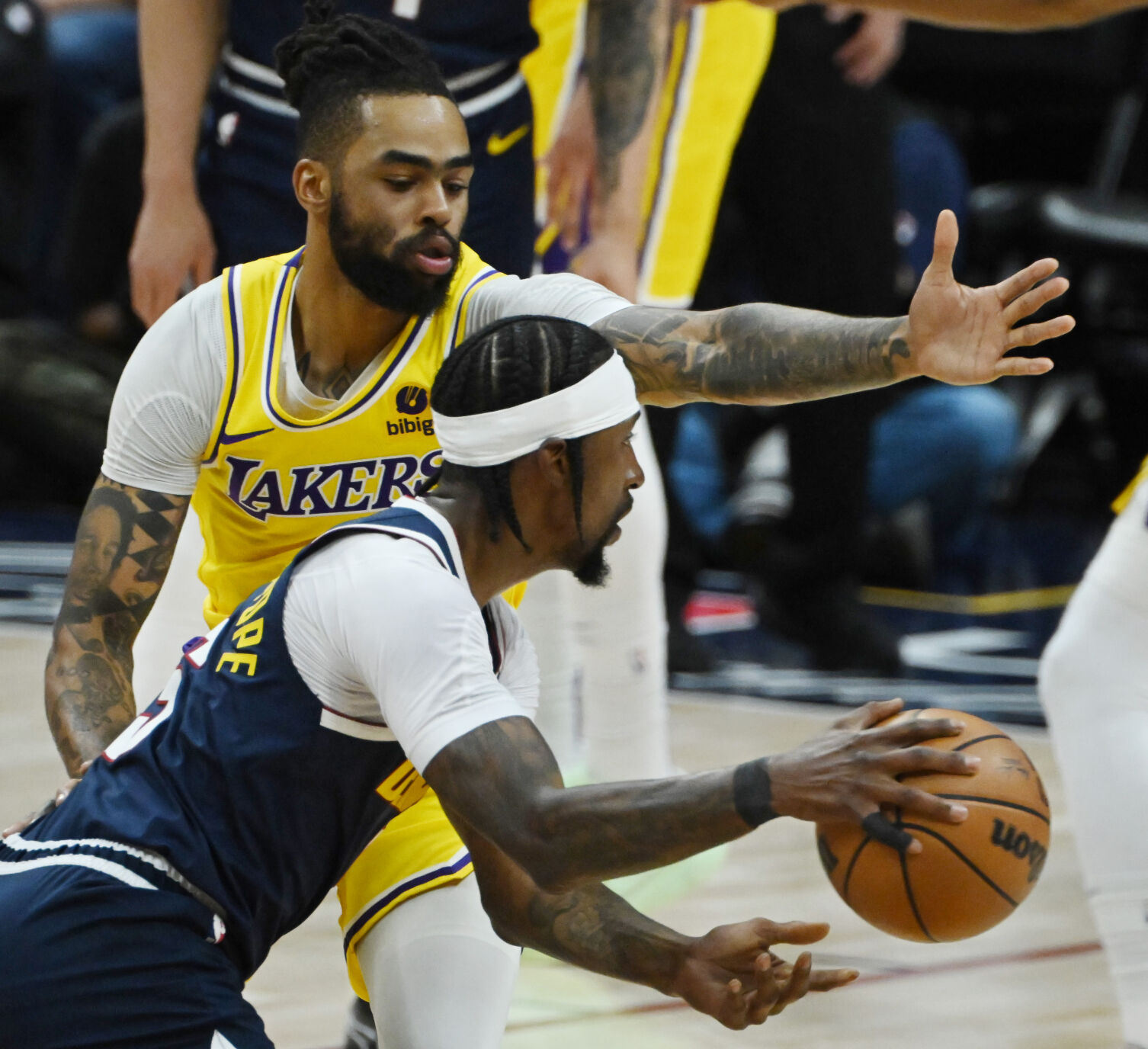 Kentavious Caldwell-Pope controls the ball while being defended by Lakers’ D’Angelo Russell during game 5 of the first round of the Western Conference championships at Ball Arena on Monday, April 24, 2024. The Nuggets won the game 108-106. (Photo by Jerilee Bennett, The Gazette)