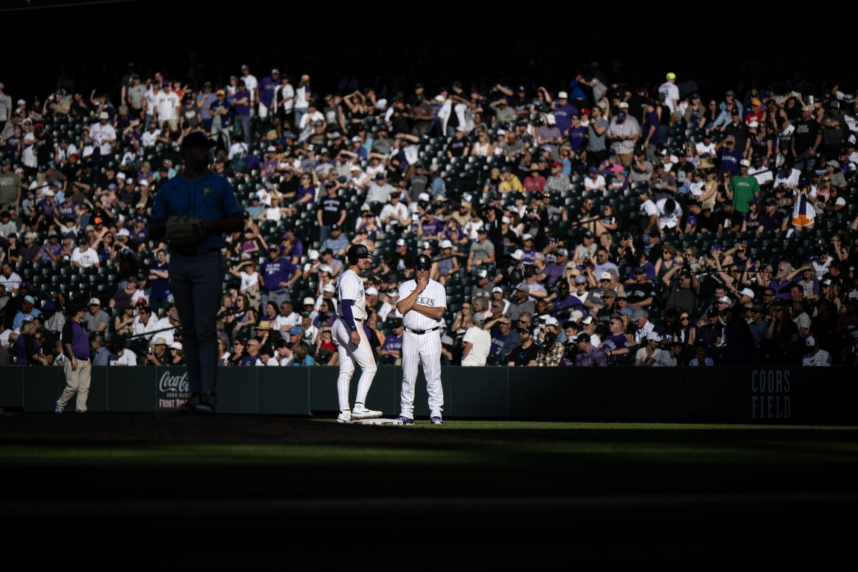 Colorado Rockies outfielder Nolan Jones (22) talks with first base coach Ron Gideon during a game against the Tampa Bay Rays at Coors Field, Friday, April 5, 2024, in Denver, Colo. (Parker Seibold, The Gazette) (Parker Seibold)