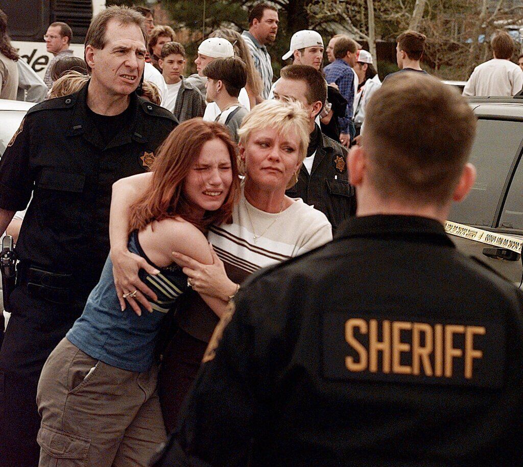 FILE PHOTO: A woman embraces her daughter after they were reunited following a shooting at Columbine High School in Littleton, Colo., on Tuesday, April, 20, 1999. As many as 25 were killed at the school by two young men who went on a shooting rampage on Tuesday. (AP Photo/Ed Andrieski) (Ed Andrieski/Associated Press)