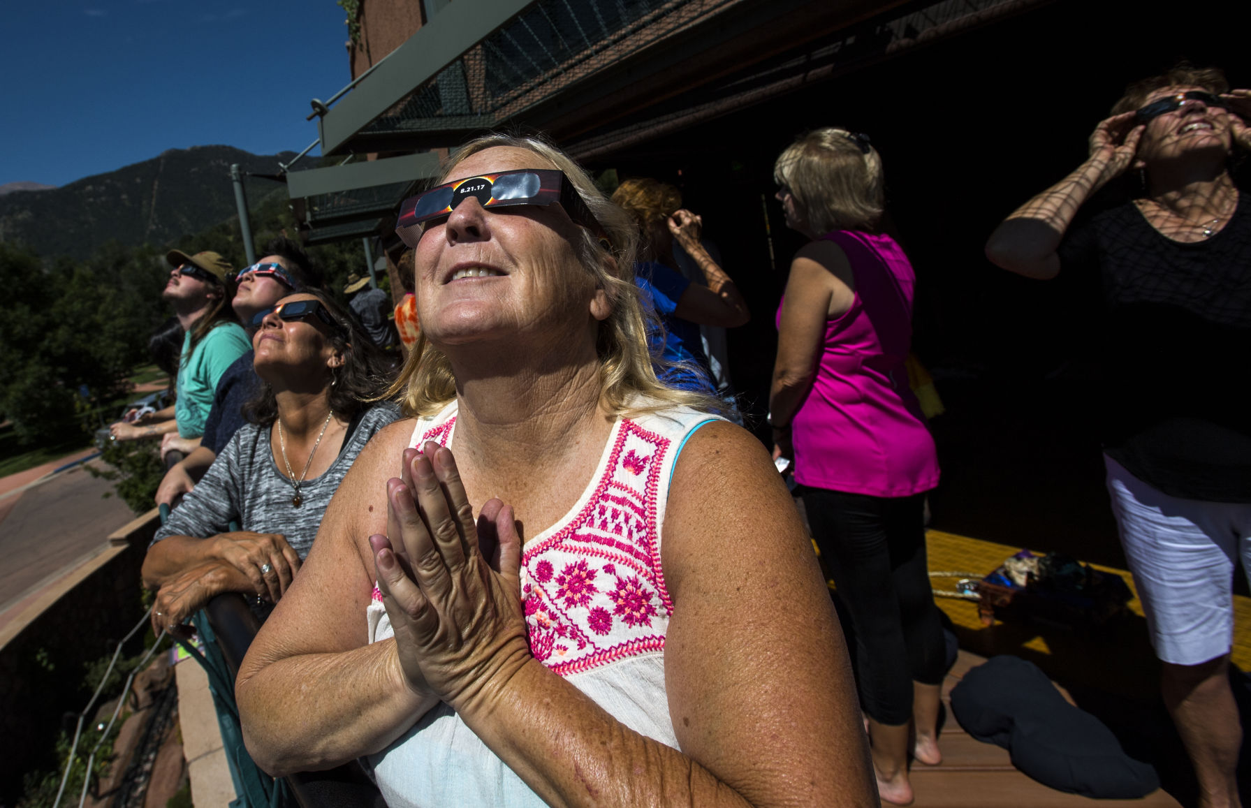 Merril Spielman watches as the moon begins to cover the sun at SunWater Spa in Manitou Springs during the solar eclipse Monday, Aug. 21, 2017. The Colorado Springs area experienced an eclipse of about 90 percent. (The Gazette, Christian Murdock) (CHRISTIAN MURDOCK, THE GAZETTE)