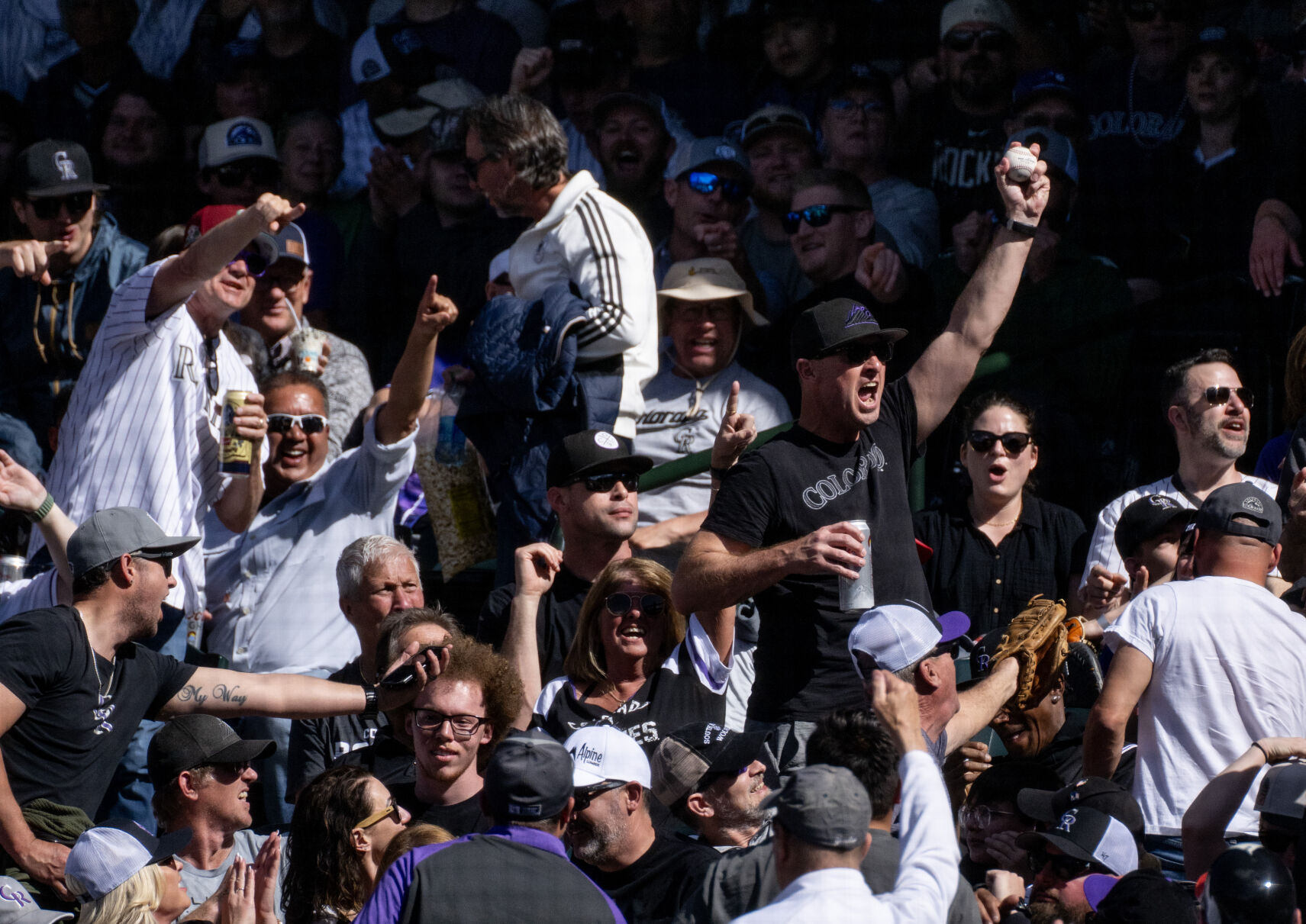 A Colorado Rockies fan celebrates after catching a foul ball during opening day at Coors Field, Friday, April 5, 2024, in Denver, Colo. (Parker Seibold, The Gazette) (Parker Seibold)