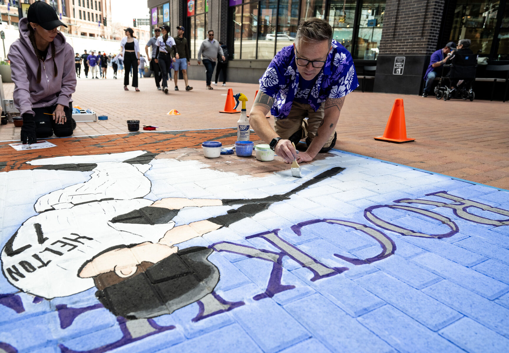 Eric Matelski paints a mural in honor of former Colorado Rockies player Todd Helton in McGregor Square before the home opener at Coors Field, Friday, April 5, 2024, in Denver, Colo. Matelski and Kyle Banister have been commissioned by the Rockies for 11 years to paint murals outside the stadium on opening day. (Parker Seibold, The Gazette) (Parker Seibold)