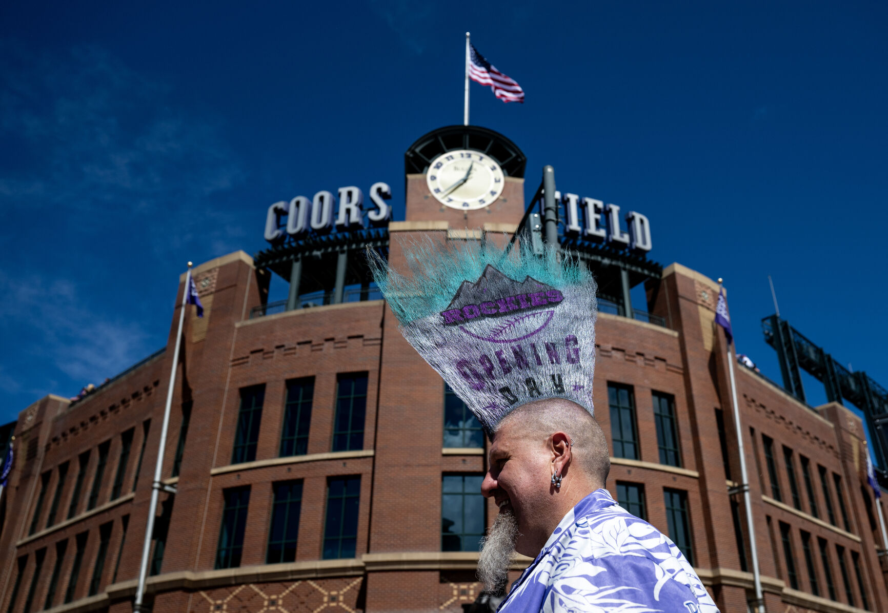 Joshua Pugh stops for a photograph in front of Coors Field, Friday, April 5, 2024, in Denver, Colo. Pugh has worn a decorated mohawk to opening day for 13 years. (Parker Seibold, The Gazette) (Parker Seibold)