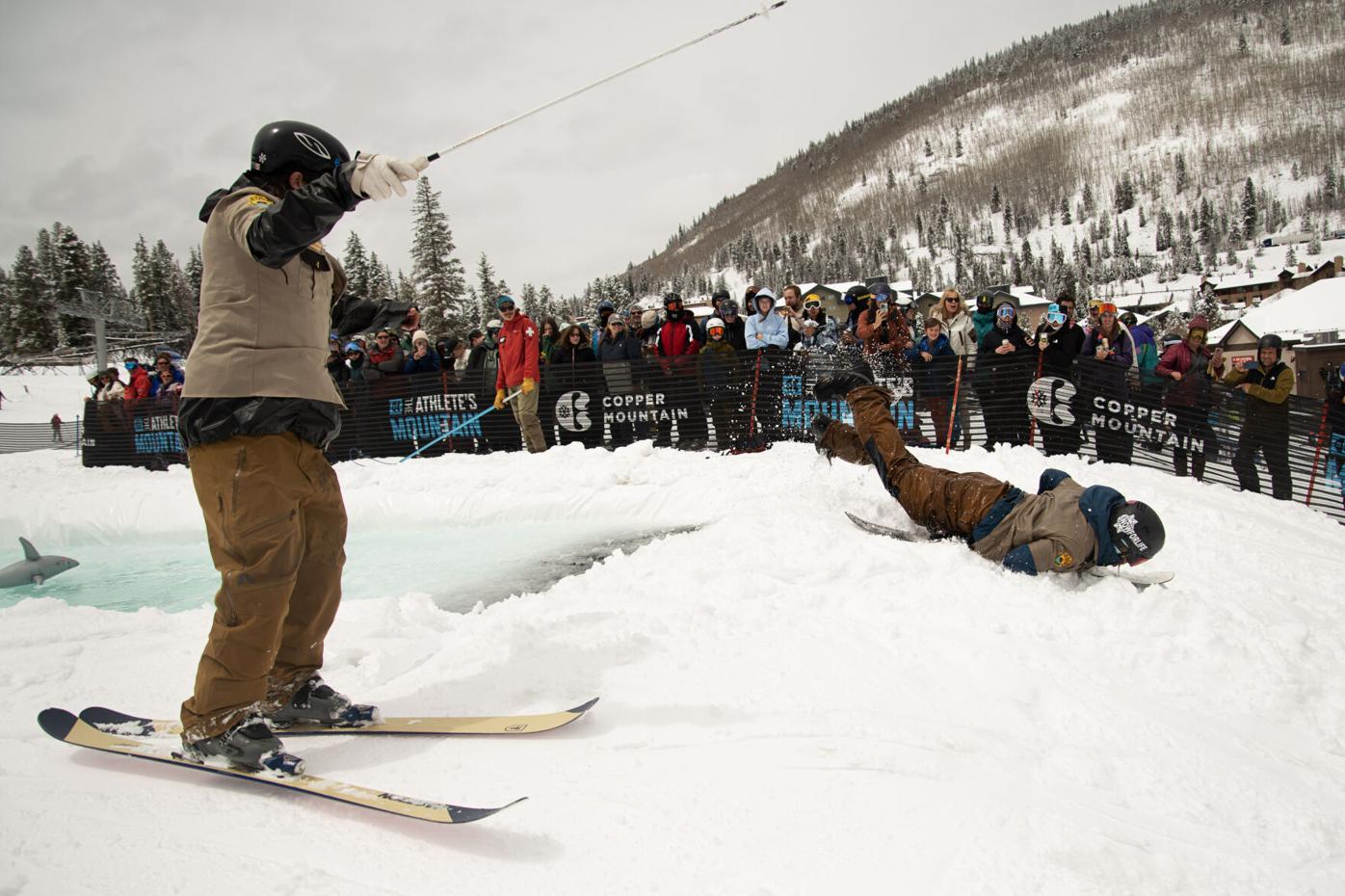 A skier belly flops out of Copper Mountain's Slush Rush pond