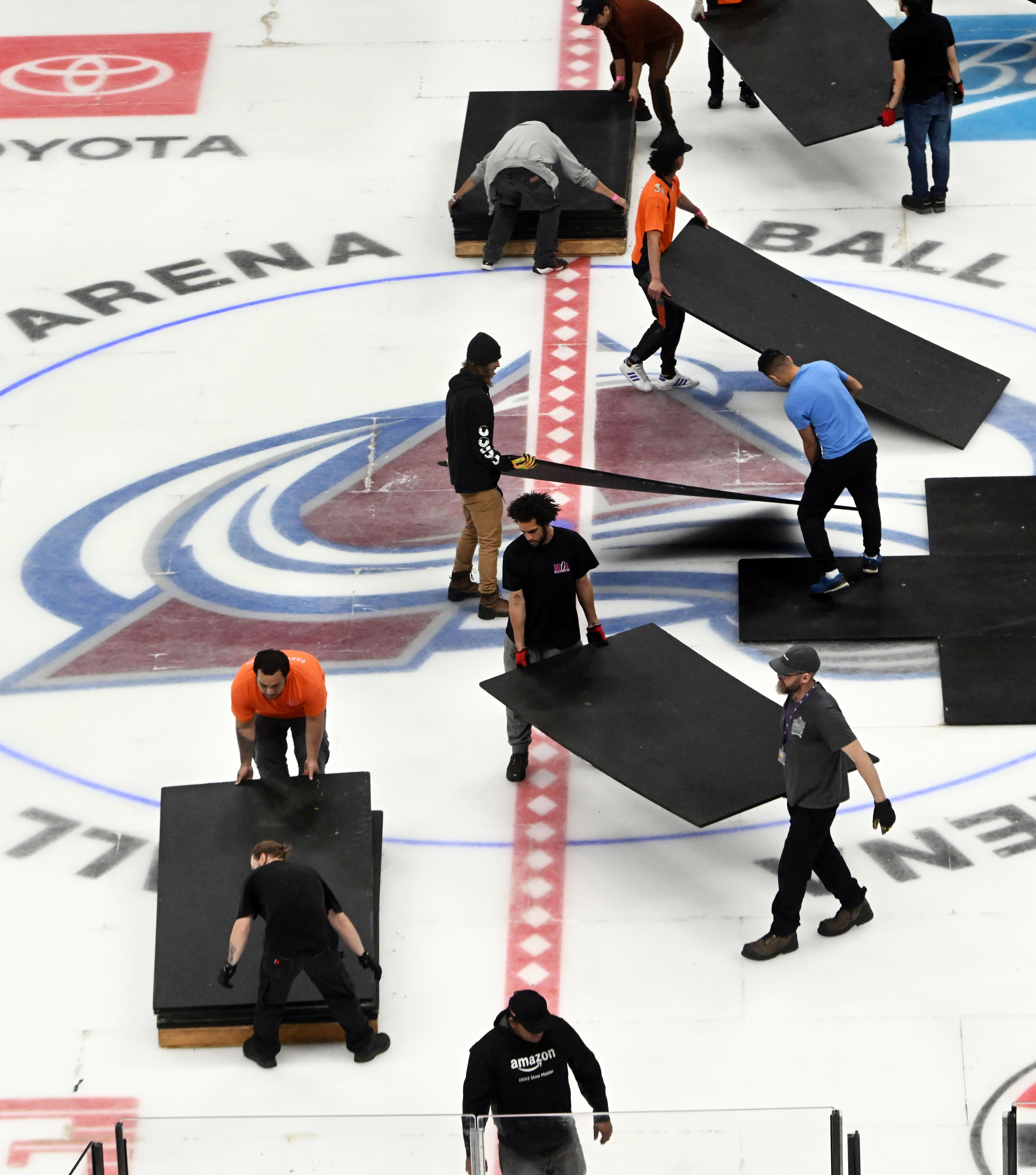 After removing the Nuggets wooden floor, crews remove tiles to reveal the Avalanche ice underneath. Crews were converting Ball Arena from Nuggets to Avalanche overnight on Thursday, March 21, 2024. (Photo by Jerilee Bennett, The Gazette)