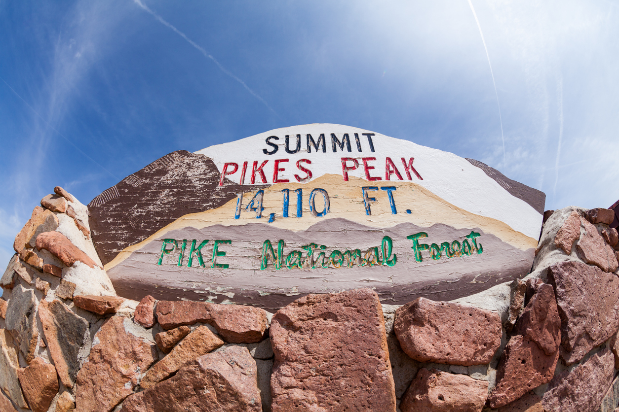 This previous summit sign lists the mountain as 14,110 feet tall. The new summit sign on the summit of Pikes Peak now reads 14,115 feet, but new data indicates that's wrong, too. Photo Credit: oscity (iStock). (oscity)