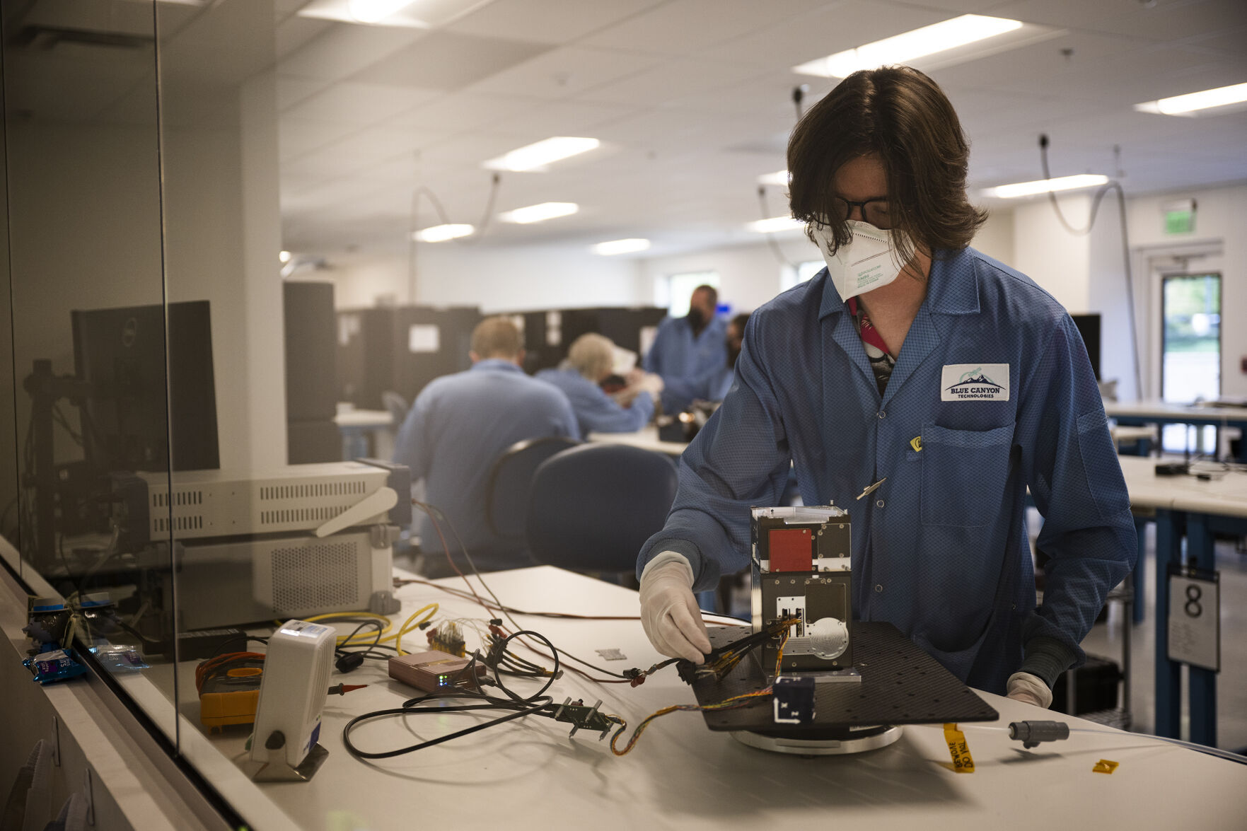 FILE PHOTO: A Blue Canyon Technologies cubist test engineer works on a avionics unit in the Infinity Lab at the company’s cubesat manufacturing facility on Wednesday, August 3, 2022, in Boulder, Colo. The company will visit the 2024 Space Symposium to showcase its methane-detecting satellite project with the former Ball Aerospace and meet with other future partners. (Timothy Hurst/Denver Gazette)