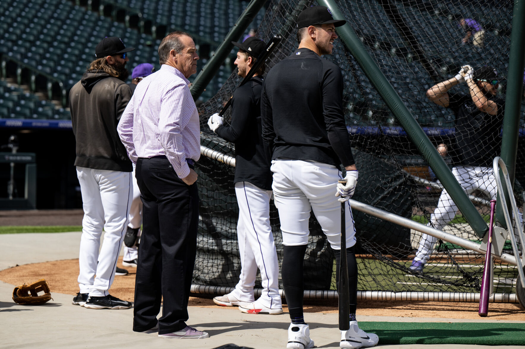 Colorado Rockies owner Richard Monfort, center, watches batting practice on opening day at Coors Field, Friday, April 5, 2024, in Denver, Colo. (Parker Seibold, The Gazette) (Parker Seibold)