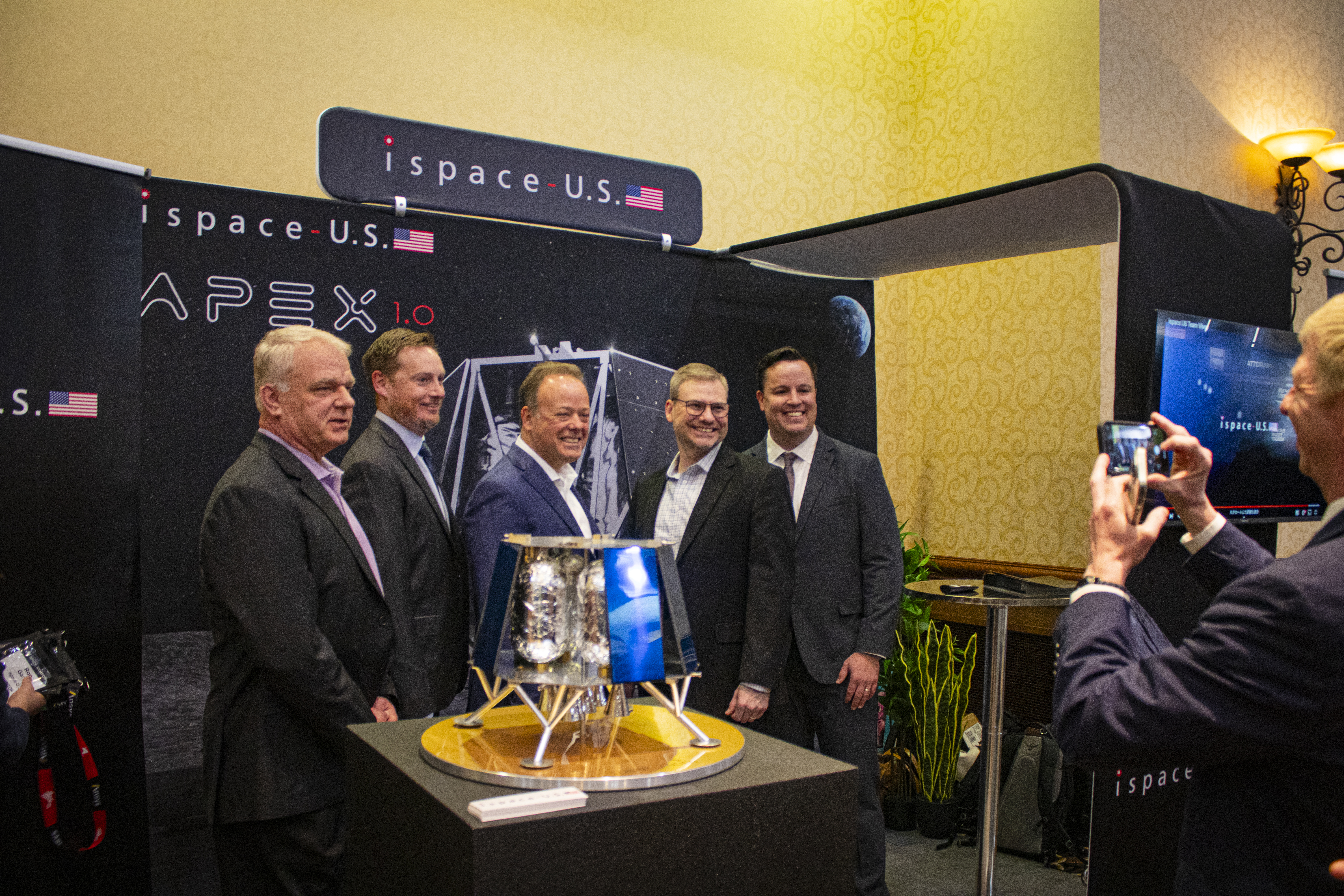 Company officials from Centennial-based ispace technologies U.S. and Lafayette-based Blue Canyon Technologies celebrate the partnership between the two Denver area companies at the Space Symposium trade show in Colorado Springs on Tuesday, April 9, 2024. (Bernadette Berdychowski / Denver Gazette)