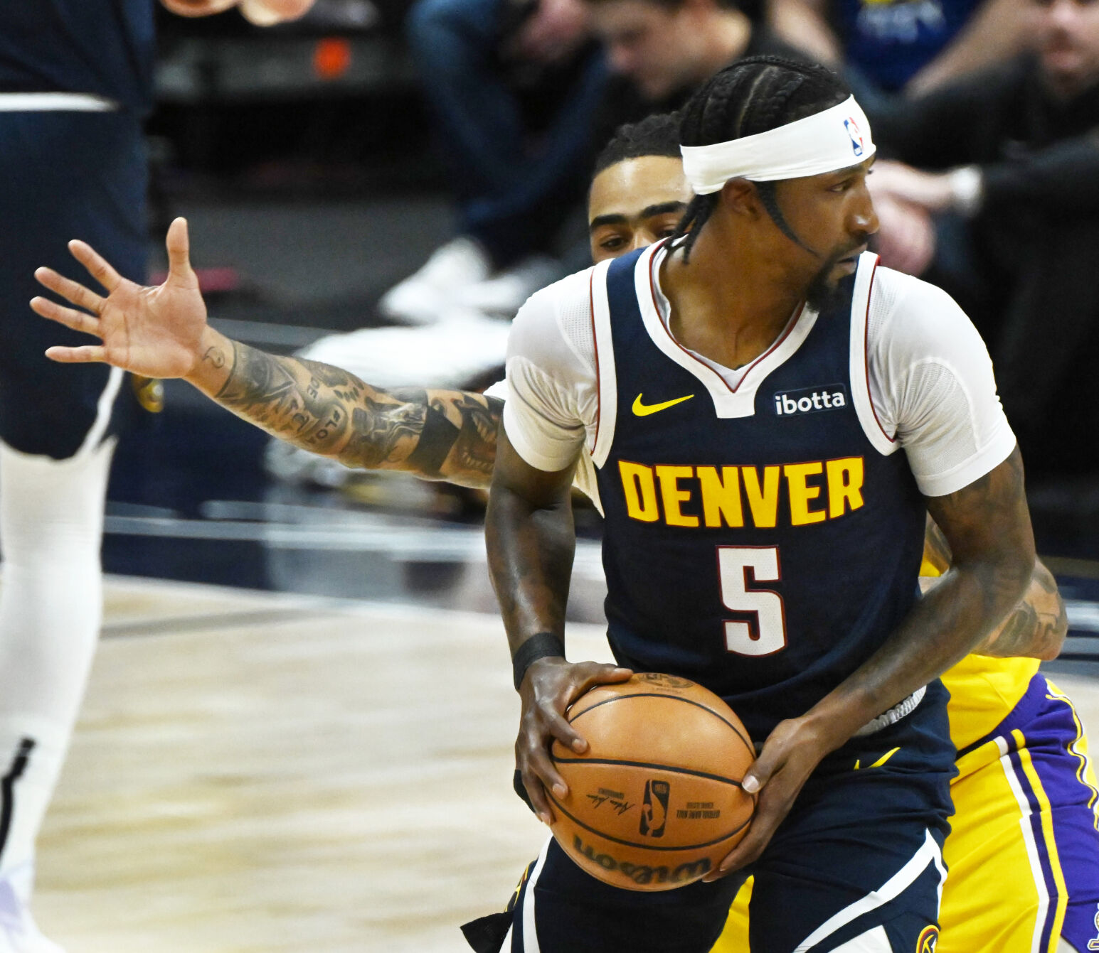 Kentavious Caldwell-Pope controls the ball while being defended by Lakers’ D’Angelo Russell during game 5 of the first round of the Western Conference championships at Ball Arena on Monday, April 24, 2024. The Nuggets won the game 108-106. (Photo by Jerilee Bennett, The Gazette)