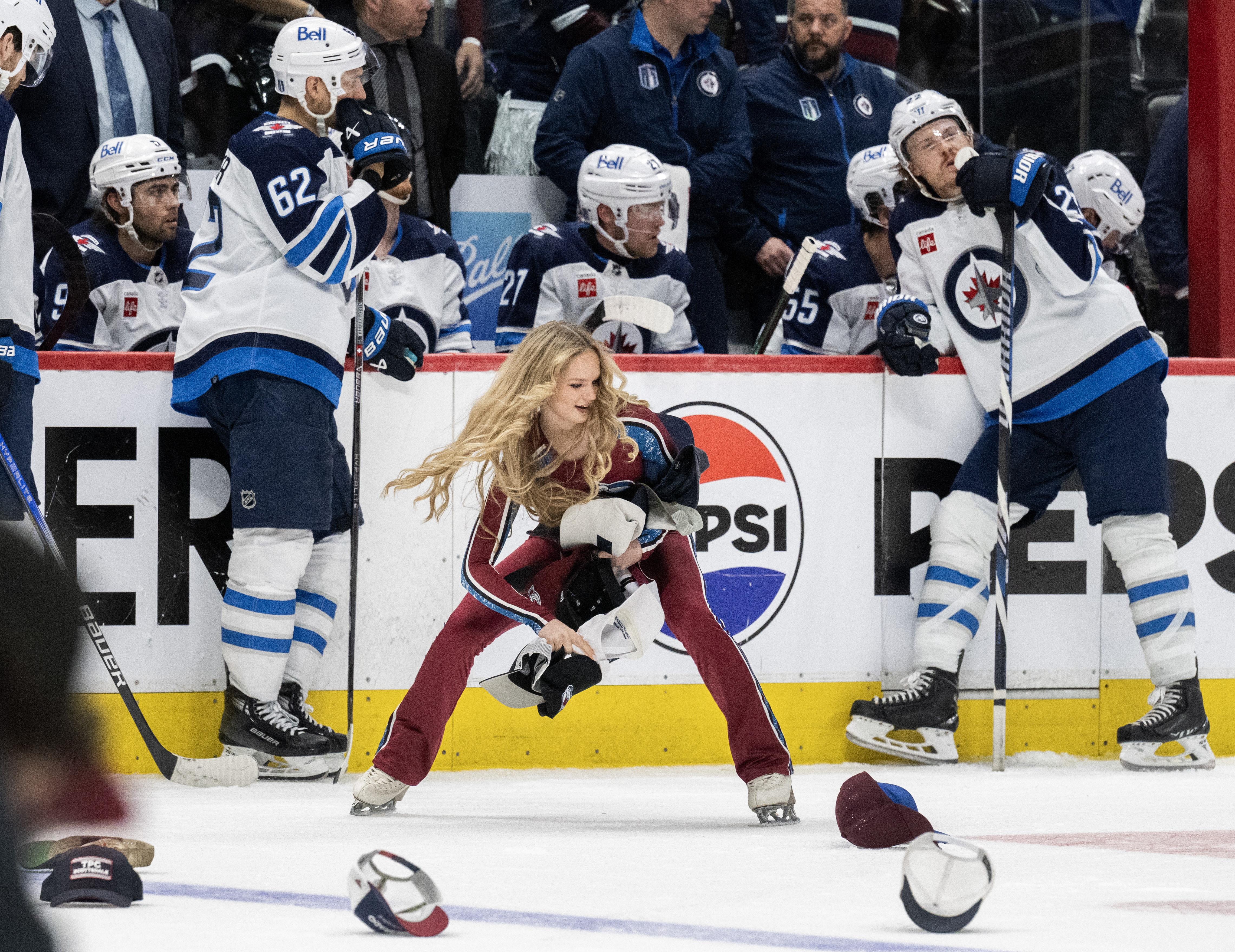 The Avalanche Ice Patrol collect the hats thrown on the ice as the Winnipeg Jets team waits after Colorado Avalanche right wing Valeri Nichushkin (13) scored his third goal for a hat trick during the third period in Game 4 of an NHL Stanley Cup first-round playoff series Sunday, April 28, 2024, at Ball Arena in Denver. The Avalanche won 5-1 to take a 3-1 advantage in the series. (The Gazette, Christian Murdock) (Christian Murdock/The Gazette)