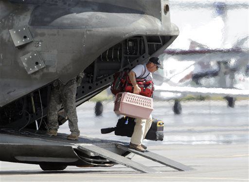 FILE PHOTO: A flood victim walks off of a military helicopter at the Boulder Municipal Airport in Boulder, Colo., on on Monday, Sept. 16, 2013, after being rescued. Thousands of people remained stranded by high water and washed out roads in the state. (AP Photo/Ed Andrieski) (Ed Andrieski/Associated Press)