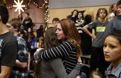 FILE PHOTO: Freshman Allie Zadrow, center right, hugs classmate Liz Reinhardt at a church after a shooting at nearby Arapahoe High School in Centennial, Colo., on Friday, Dec. 13, 2013. Students from the school were evacuated to the church. Arapahoe County Sheriff Grayson Robinson said the shooter shot two others at the school, before apparently killing himself. (AP Photo/Brennan Linsley) (Brennan Linsley/Associated Press)