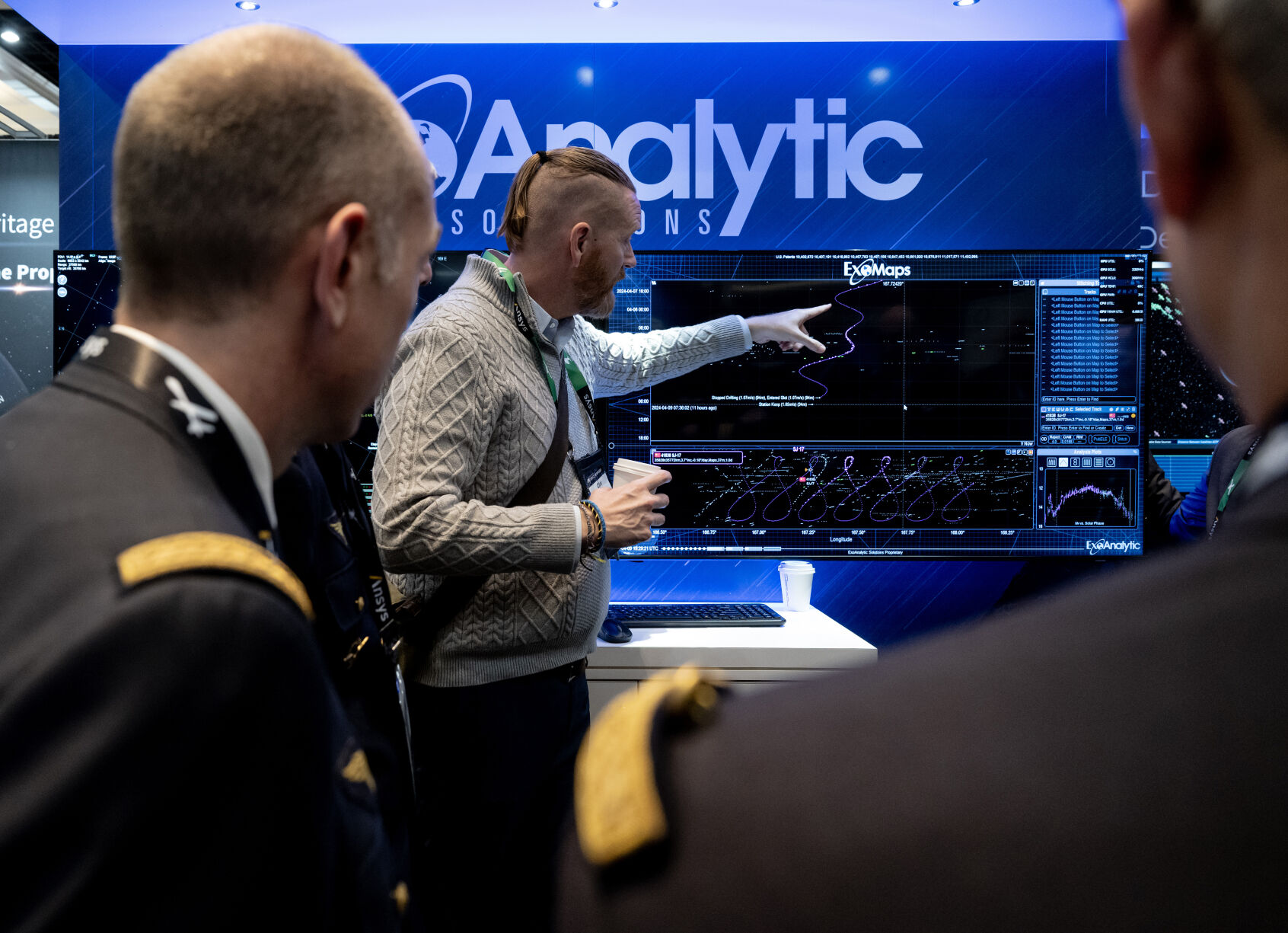 Clint Clark with ExoAnalytic Solutions speaks to a small group gathered in front of the exhibition at the 39th Space Foundation Space Symposium at The Broadmoor Hotel, Tuesday, April 9, 2024, in Colorado Springs, Colo. (Parker Seibold, The Gazette) (Parker Seibold)