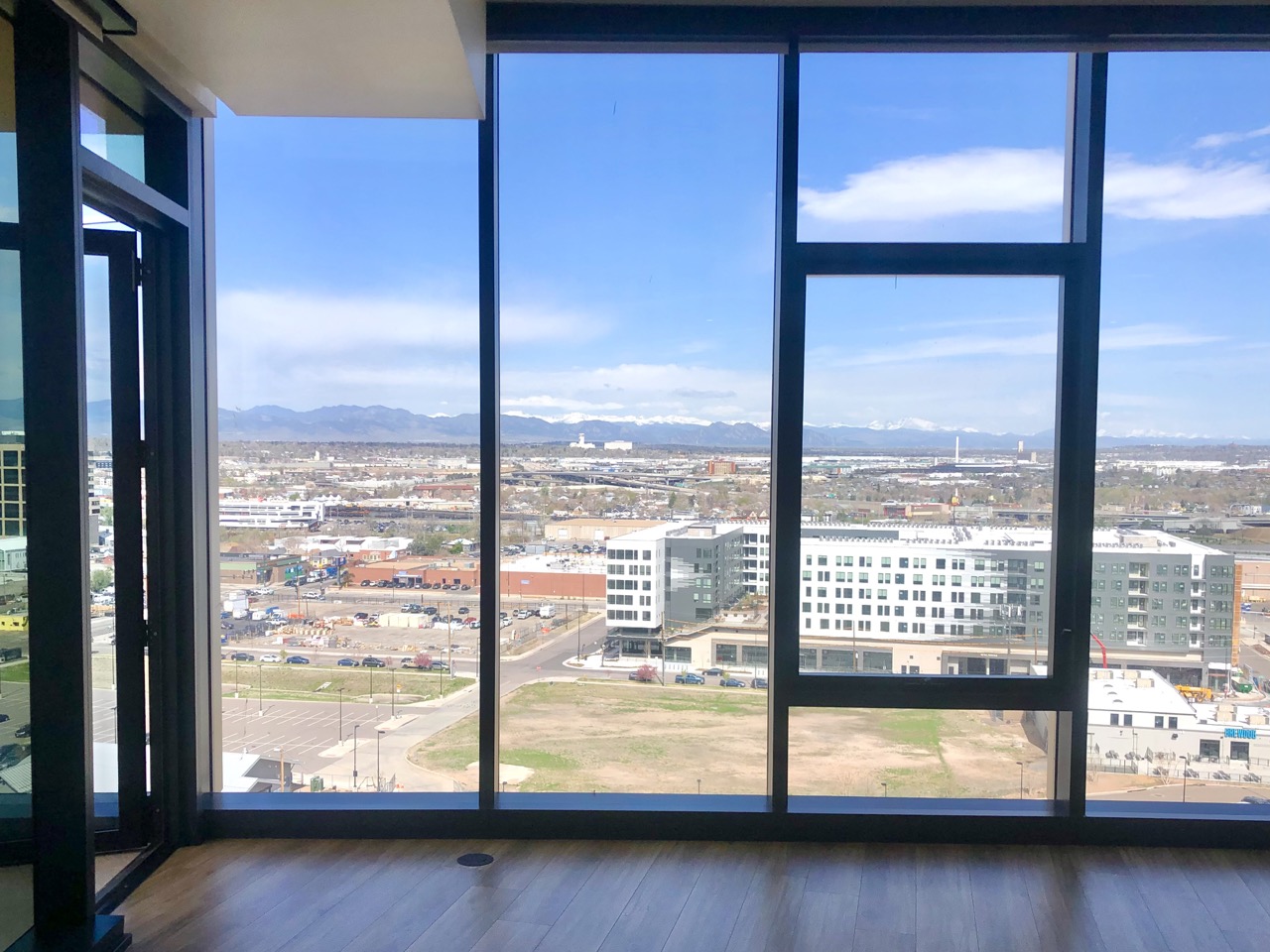 Inside an apartment at One River North in Denver's RiNo District on April 23, 2024. The unit with 12 ft. ceilings has expansive views of the Rocky Mountains and downtown Denver's skyline. (Bernadette Berdychowski / Denver Gazette)