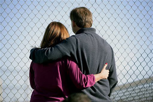 FILE PHOTO: Parents stand along the tennis court fence hoping to see if their child is standing outside on the football field after a gunman was spotted inside Arapahoe High School on Friday, Dec. 13, 2013, in Centennial, Colo. Authorities said the gunman shot two students and then turned the gun on himself. The shooting came a day before the anniversary of the Newtown, Conn., attack in which a gunman killed 20 children and six adults at Sandy Hook Elementary School. (AP Photo/The Denver Post, John Leyba) MAGS OUT; TV OUT; INTERNET OUT; NO SALES; NEW YORK POST OUT; NEW YORK DAILY NEWS OUT (John Leyba/Associated Press via Denver Post)