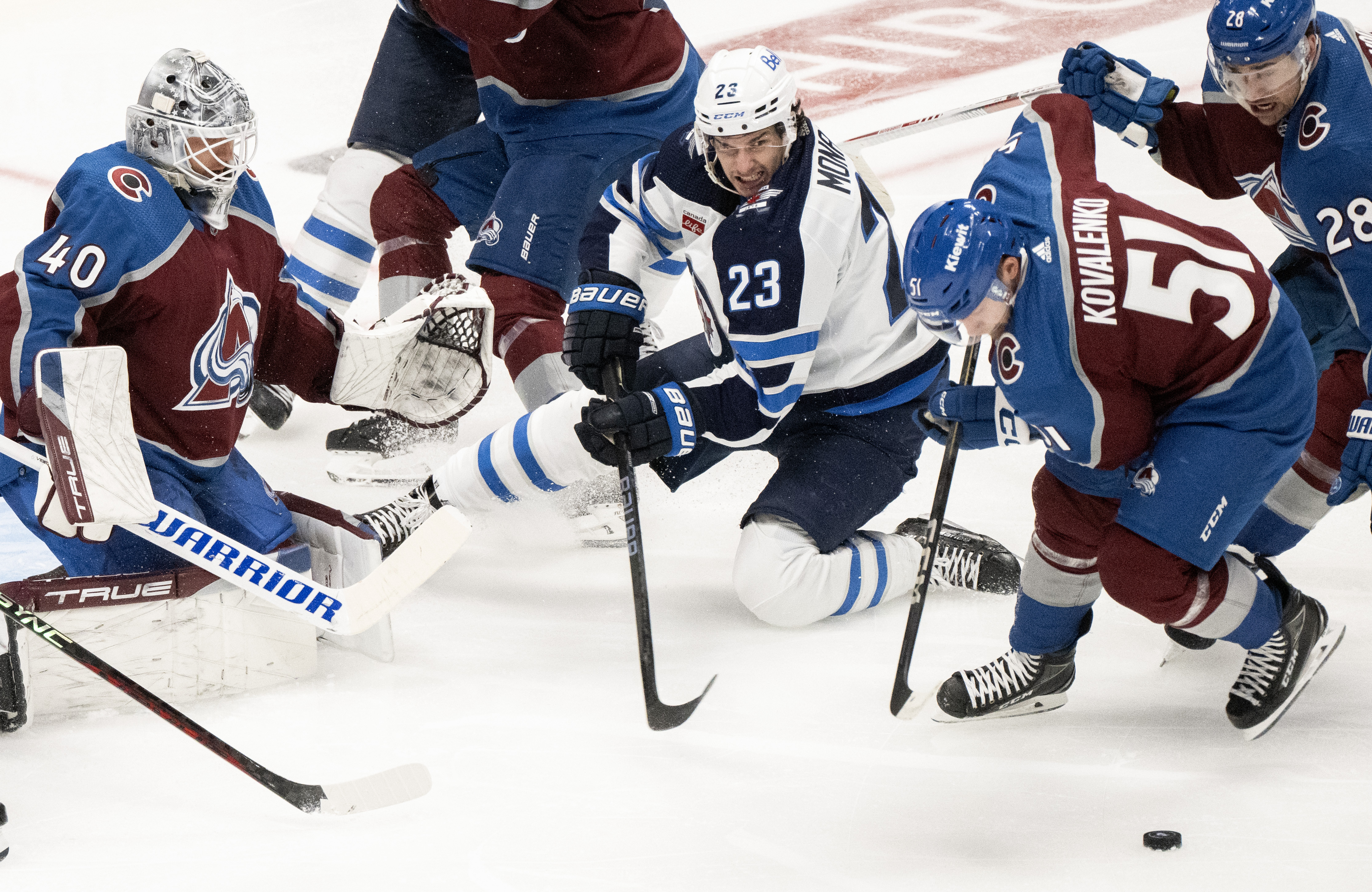 Winnipeg Jets center Sean Monahan (23) battles Colorado Avalanche forward Nikolai Kovalen for the puck in front of the Avalanche goal during the second period in Game 4 of an NHL Stanley Cup first-round playoff series Sunday, April 28, 2024, at Ball Arena in Denver. (The Gazette, Christian Murdock) (Christian Murdock/The Gazette)