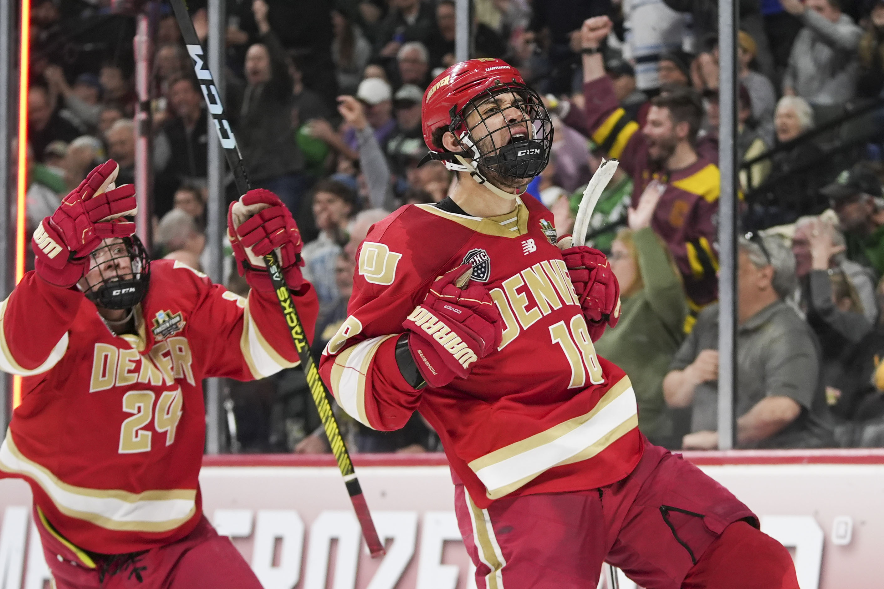 Denver forward Jared Wright (18) and forward Kieran Cebrian (24) celebrate a goal during the second period against Boston College in the championship game of the Frozen Four NCAA college hockey tournament Saturday, April 13, 2024, in St. Paul, Minn. (AP Photo/Abbie Parr) (Abbie Parr)