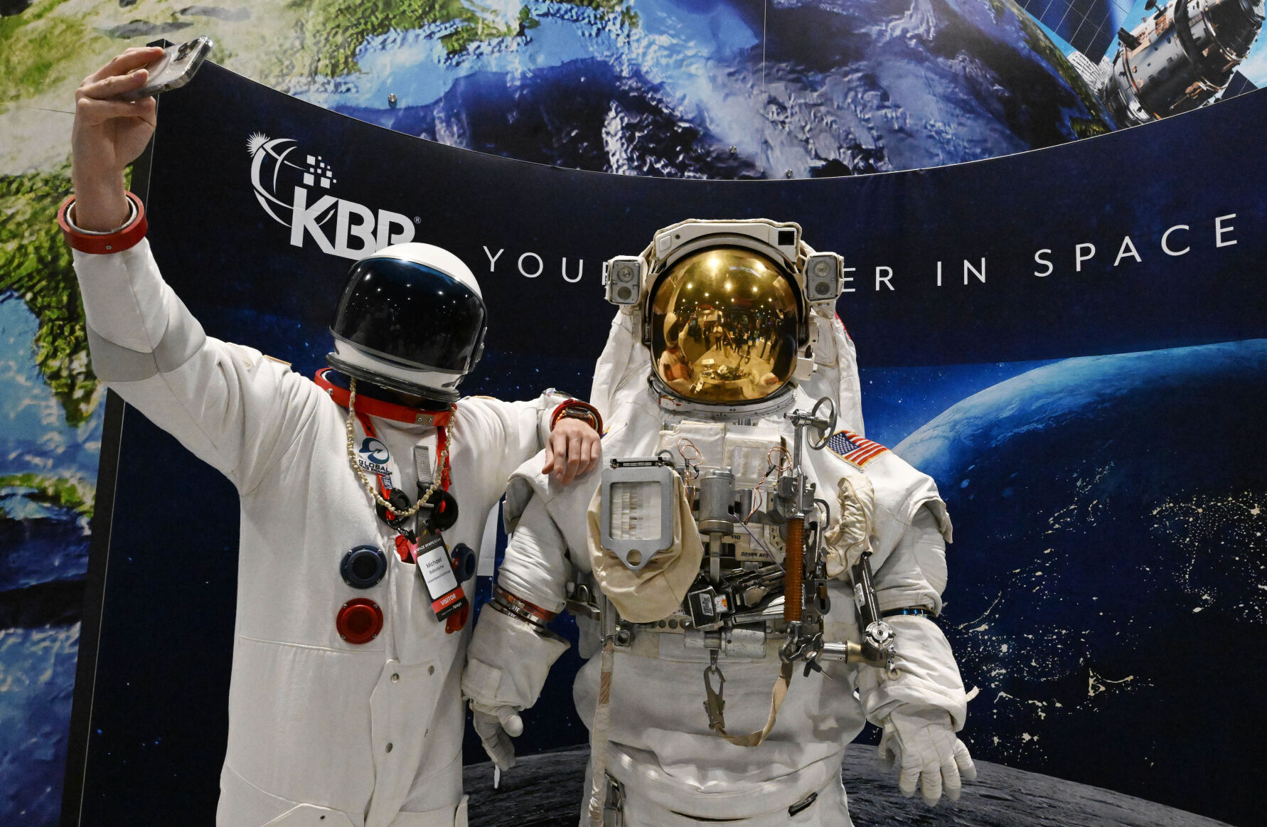 FILE PHOTO: Dressed in a costume astronaut suit, Michael Ballantyne, with Global Space Exchange, takes a selfie with the real thing at the KBR exhibit at the 38th Space Symposium at the Broadmoor Hotel on Tuesday, April 18, 2023. This year's Space Symposium is Monday through Thursday, April 11. (Jerilee Bennett, The Gazette)
