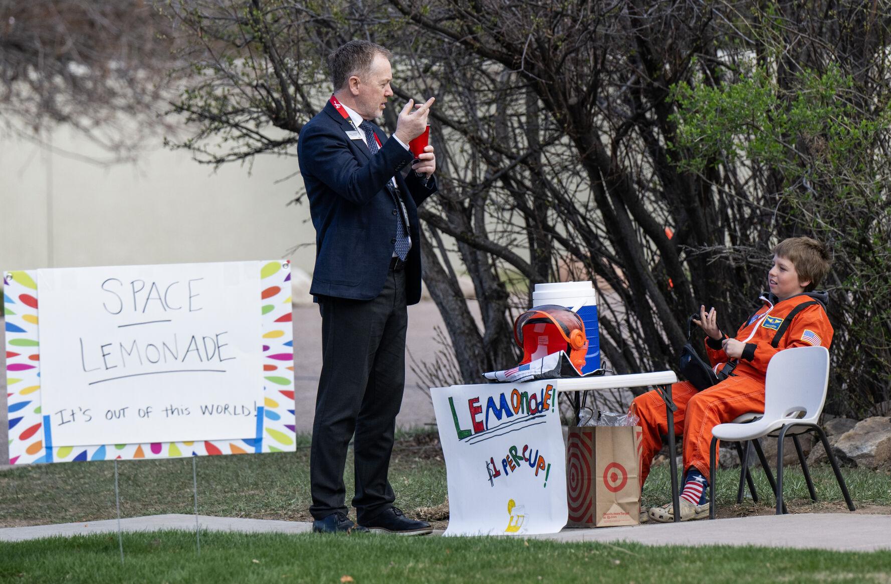 Dressed in a costume NASA astronaut suit, Dominic Delano sells lemonade from the sidewalk outside of The Broadmoor Hotel to passersby from the 39th Space Foundation Space Symposium, Tuesday, April 9, 2024, in Colorado Springs, Colo. (Parker Seibold, The Gazette) (Parker Seibold)