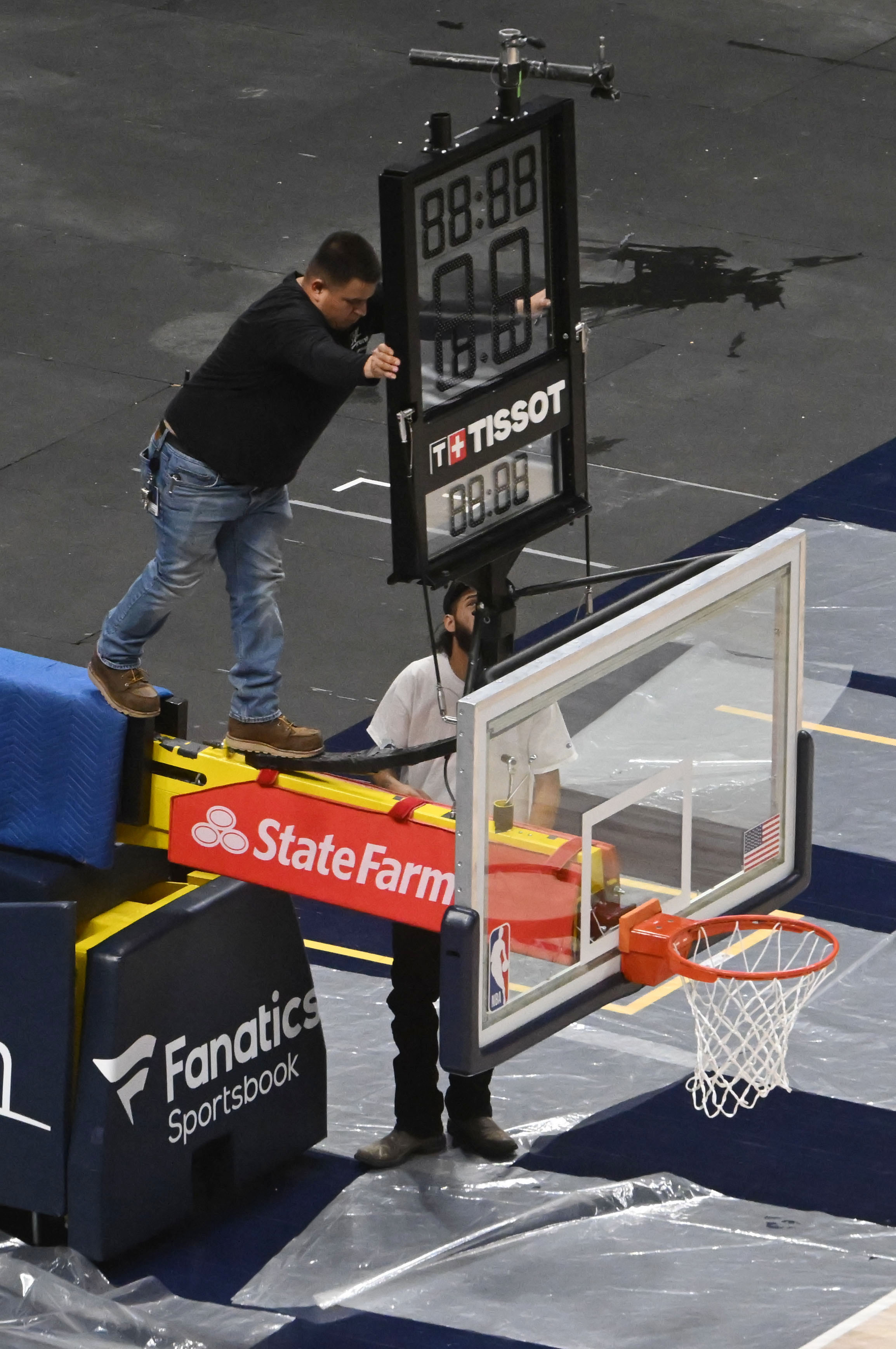 The basketball goal is readied for removal after a Nuggets game . Ball Arena was transformed from Nuggets to Avalanche overnight on Thursday, March 21, 2024. (Photo by Jerilee Bennett, The Gazette)