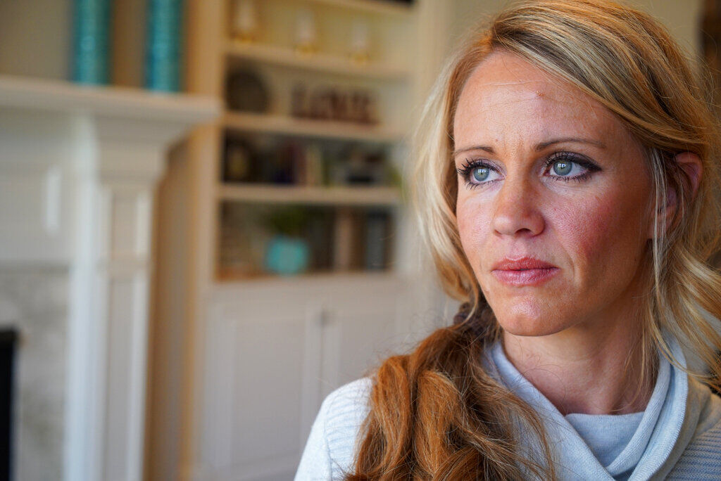 FILE PHOTO: In this March 27, 2019, photo, Kacey Ruegsegger Johnson poses for a portrait at her home in Cary, N.C. Ruegsegger Johnson, now a mother of four, survived a shotgun blast during the 1999 shootings at Colorado's Columbine High School that left 12 students, one teacher, and both gunmen dead. The emotional toll of the shooting, joined by fears about their own kids’ safety, spikes each time yet another shooter enters another school. (AP Photo/Allen G. Breed) (Allen G. Breed/Associated Press)