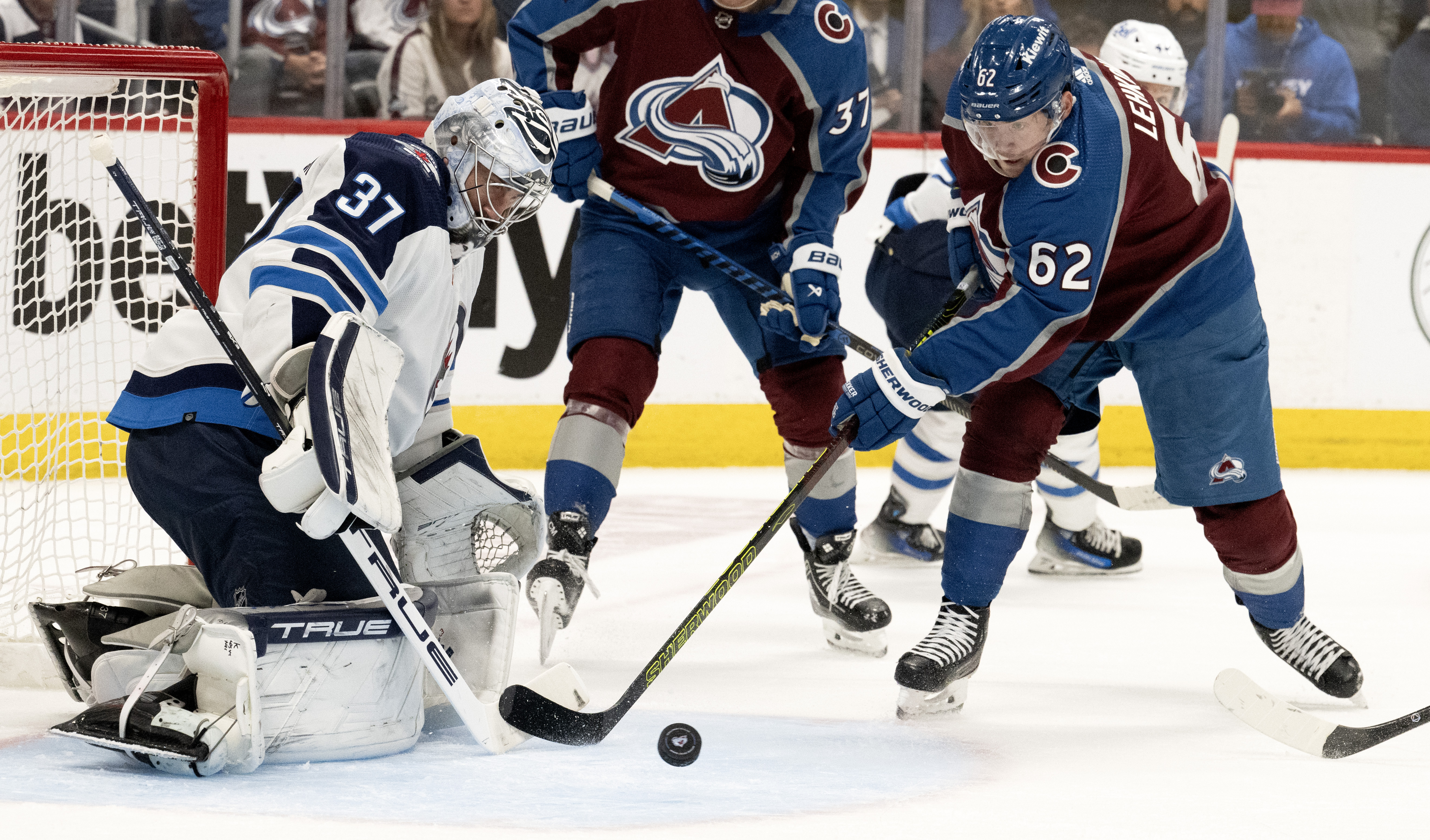 Colorado Avalanche left wing Artturi Lehkonen (62) looks for a rebound as Winnipeg Jets goaltender Connor Hellebuyck (37) defends during the first period in Game 4 of an NHL Stanley Cup first-round playoff series Sunday, April 28, 2024, at Ball Arena in Denver. (The Gazette, Christian Murdock) (Christian Murdock/The Gazette)