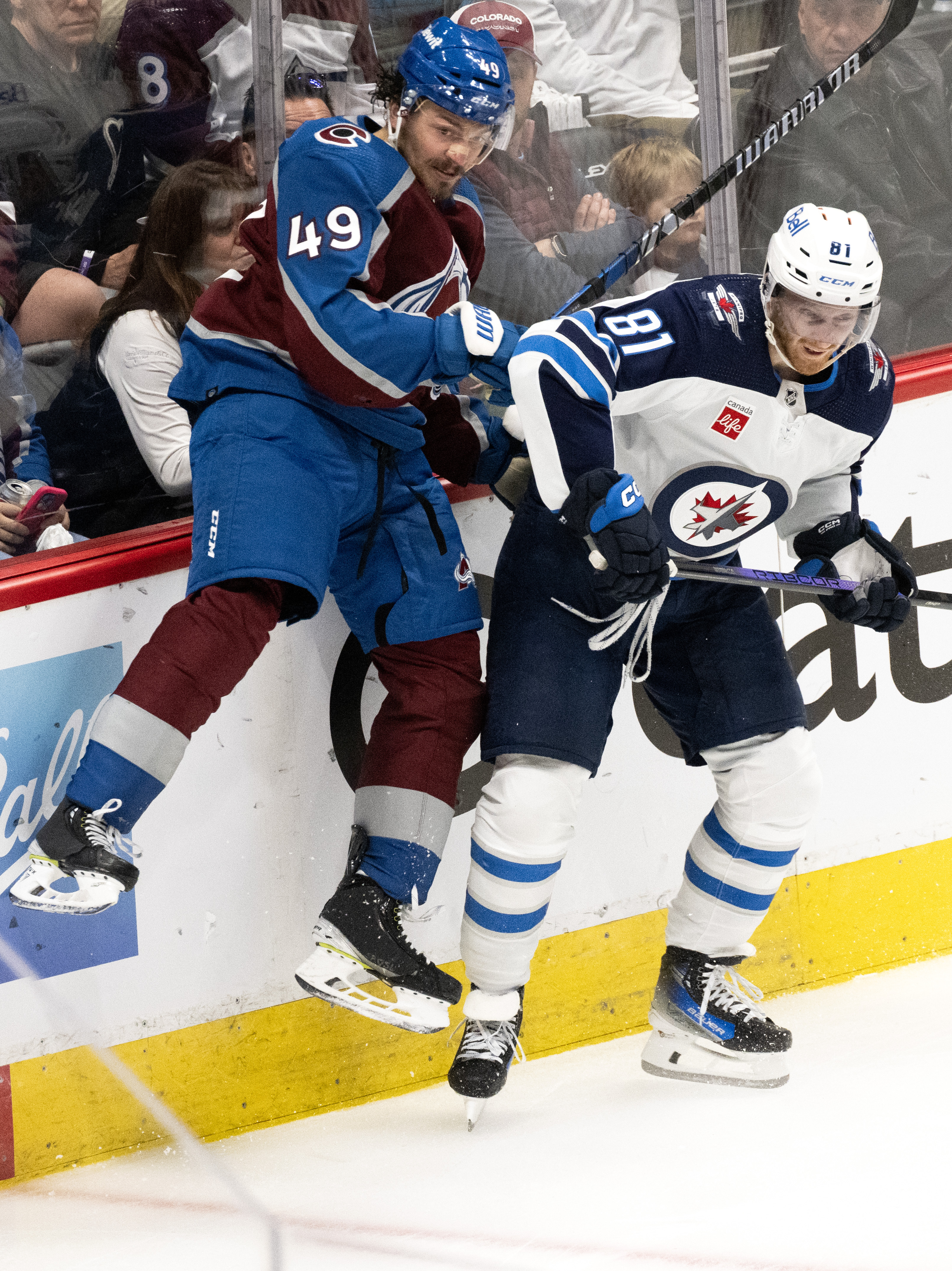Winnipeg Jets left wing Kyle Connor (81) checks Colorado Avalanche defenseman Samuel Girard (49) into the boards during the second period in Game 4 of an NHL Stanley Cup first-round playoff series Sunday, April 28, 2024, at Ball Arena in Denver. (The Gazette, Christian Murdock) (Christian Murdock/The Gazette)