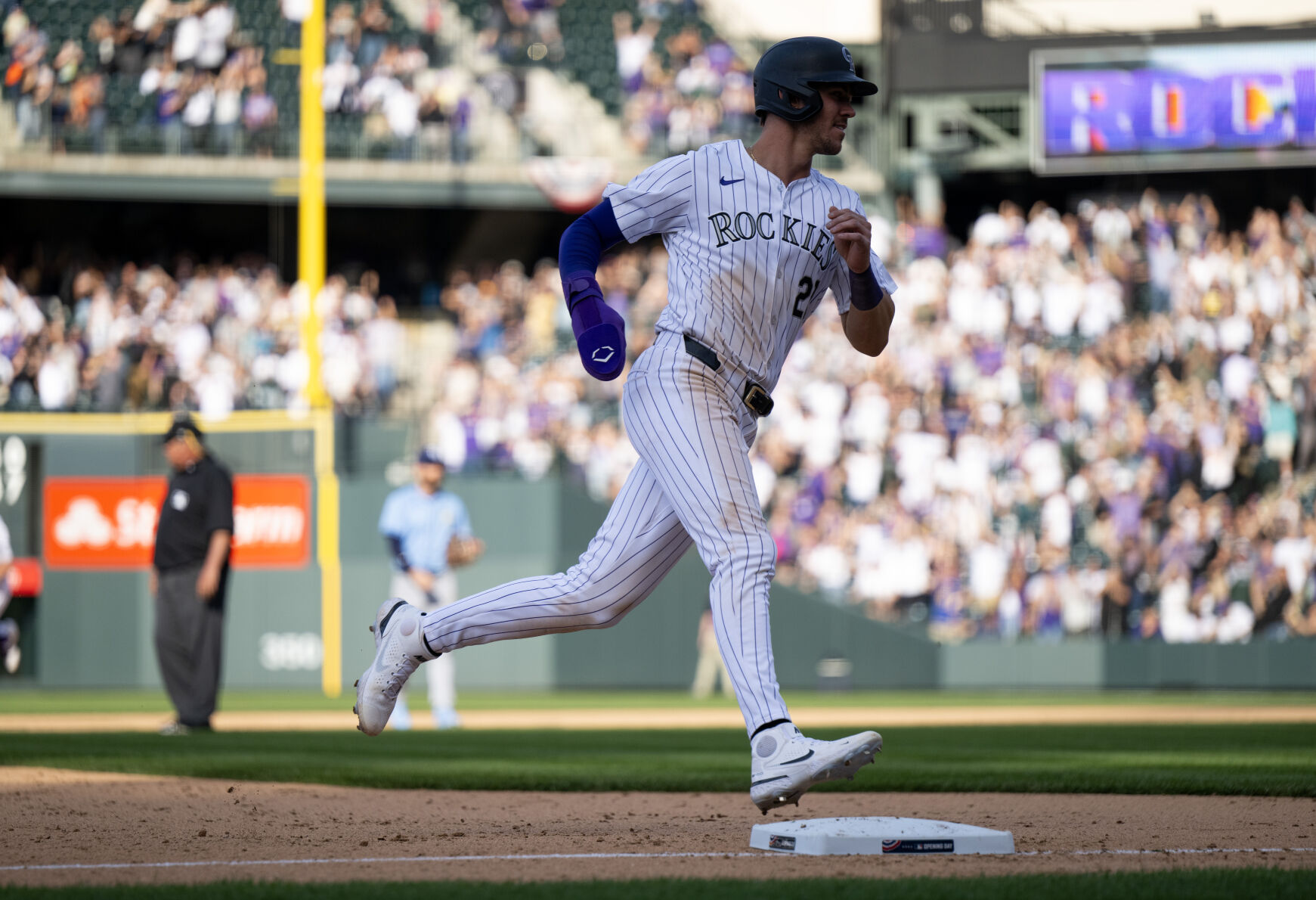 Colorado Rockies outfielder Nolan Jones (22) rounds third base after teammate Ryan McMahon (24) hit a home run to win the game against the Tampa Bay Rays at Coors Field, Friday, April 5, 2024, in Denver, Colo. (Parker Seibold, The Gazette) (Parker Seibold)