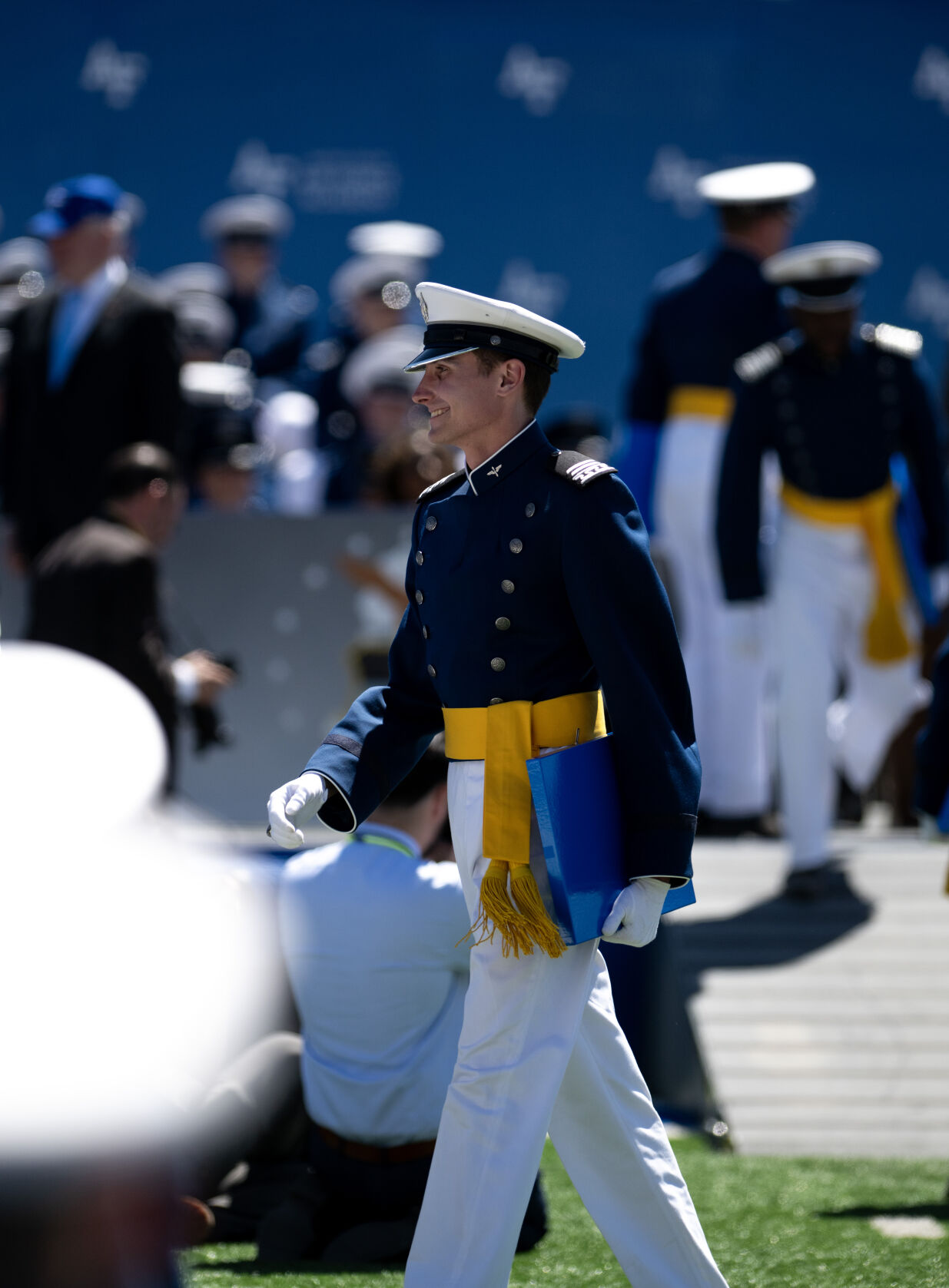 A graduate walks back to their seat during the United States Air Force Academy graduation at Falcon Stadium on Thursday, May 30, 2024, in Colorado Springs, Colo. (Parker Seibold, The Gazette) (Parker Seibold)