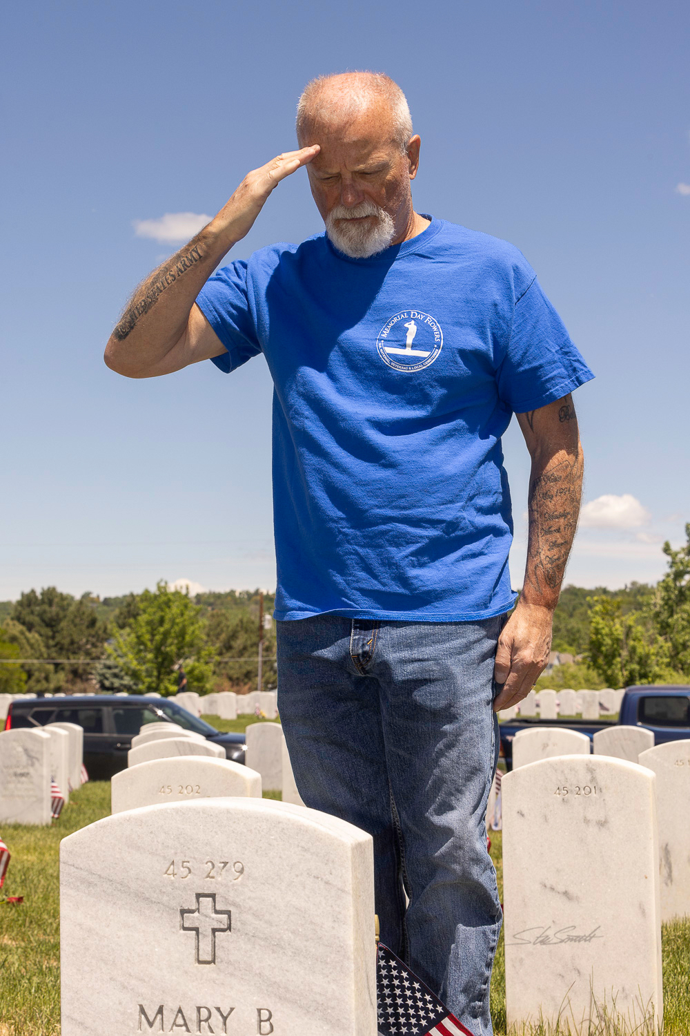 Retired U.S. Army Colonel Mikel Burroughs renders a salute at the foot of a fellow veteran's grave. Through his nonprofit organization Victory for Veterans, Burroughs hopes to ensure every deceased veteran is remembered on Memorial Day. (Courtesy photo, Stu Smith)