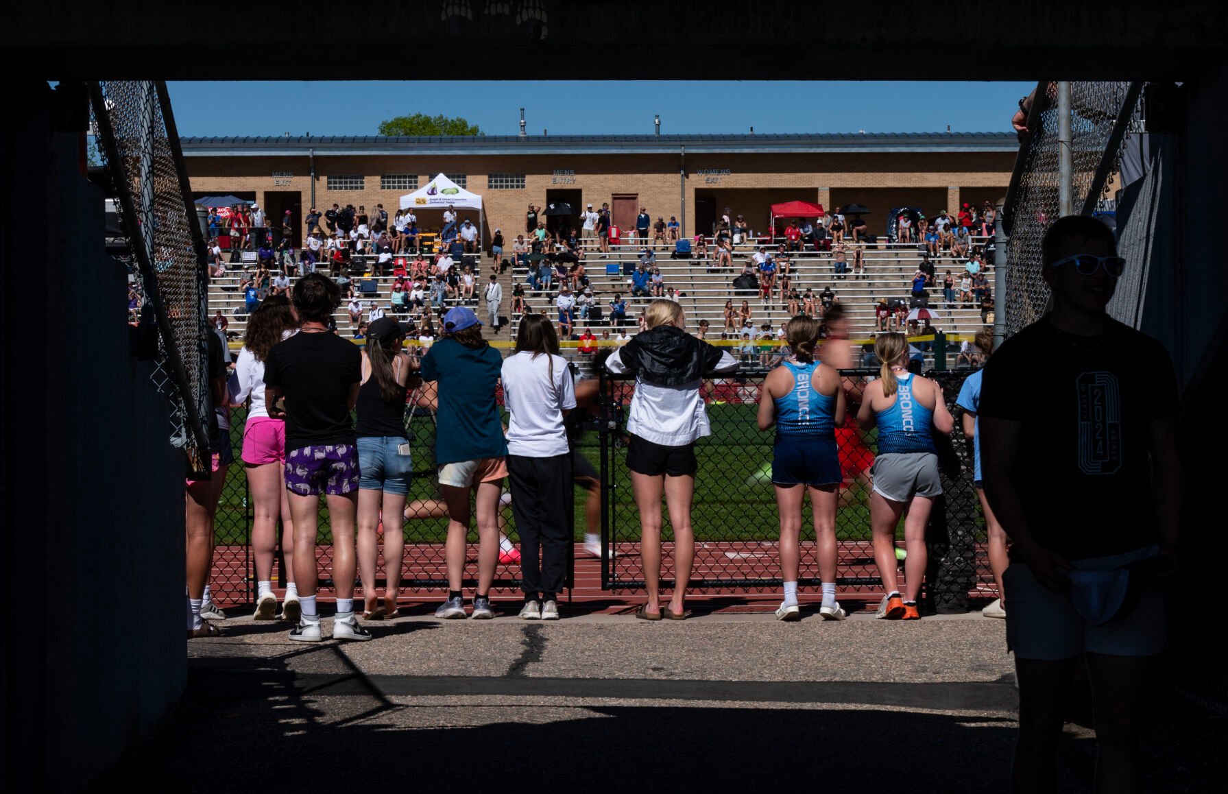Spectators and athletes watch a preliminary relay at the Colorado High School Activities Association state track and field championships on Friday, May 17, 2024, at Jeffco Stadium in Lakewood, Colo. (Parker Seibold, The Gazette) (Parker Seibold)