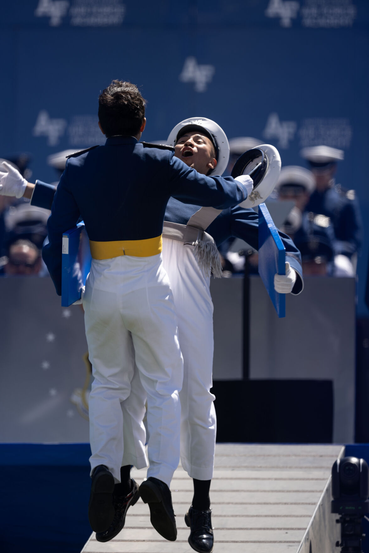 Air Force Graduates give each other a chest bump after receiving their diplomas during the Air Force Academy Graduation on Thursday, May 30, 2024. (Stephen Swofford, The Gazette) (Stephen Swofford The Gazette)