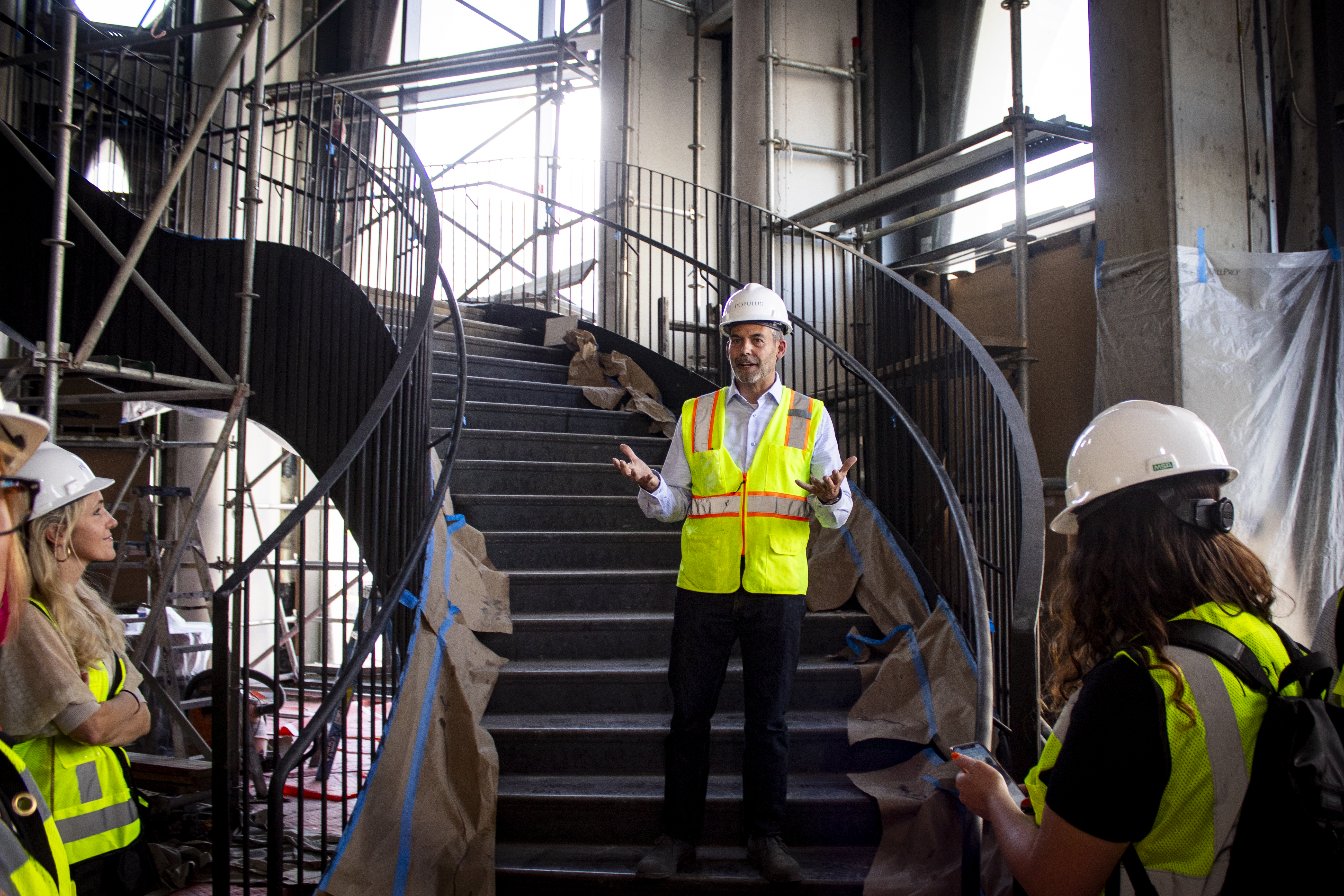 Populus Hotel general manager George Prine stands on a curved staircase during a media tour on May 30, 2024 of the downtown Denver building. (Bernadette Berdychowski / Denver Gazette)