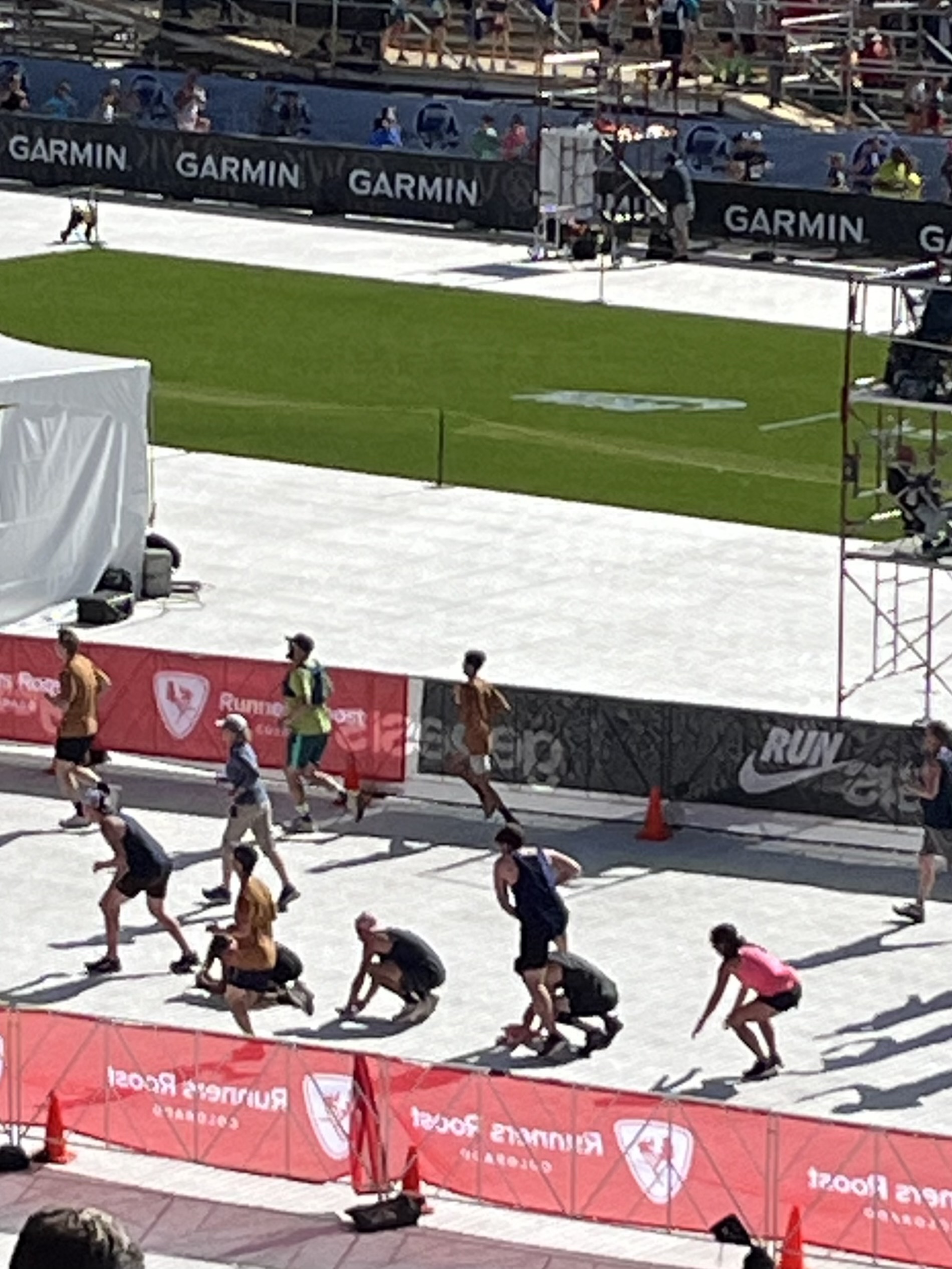 Finishers in the 44th BOLDERBoulder running event leap-frog over each other in Folsom Field on the University of Colorado Boulder campus, Monday, May 27, 2024. (Jim Trotter/Denver Gazette)