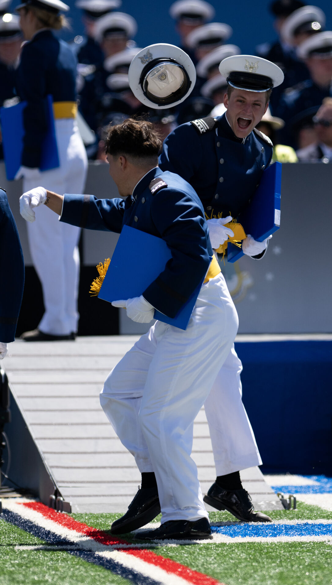 A graduate loses their hat during a moment of celebration at the United States Air Force Academy graduation at Falcon Stadium on Thursday, May 30, 2024, in Colorado Springs, Colo. (Parker Seibold, The Gazette) (Parker Seibold)